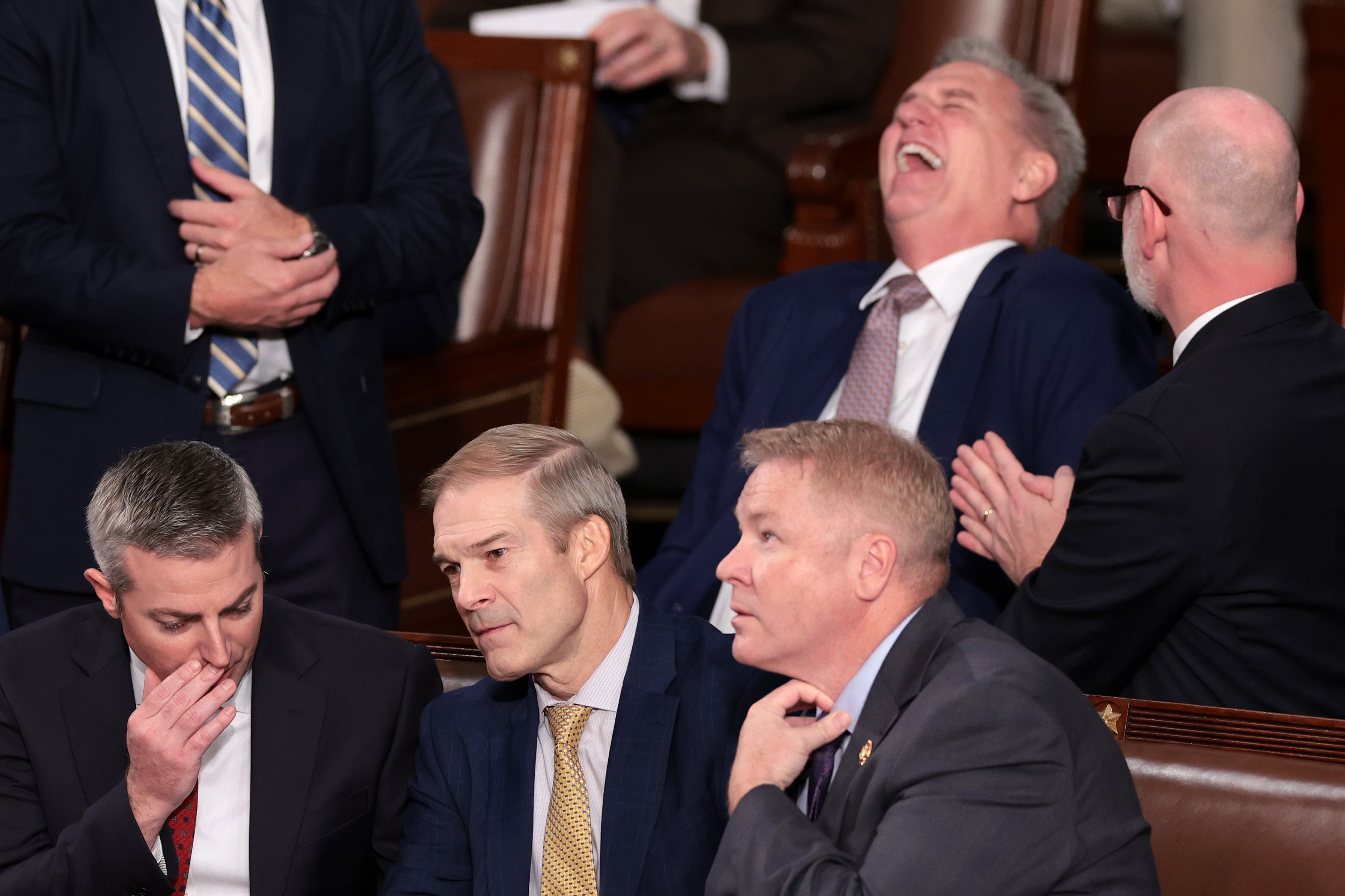 Representative Jim Jordan (R-OH) (C) talks to a staff member and Rep. Warren Davidson (R-OH) (R) while former Speaker of the House Kevin McCarthy (R-CA) laughs