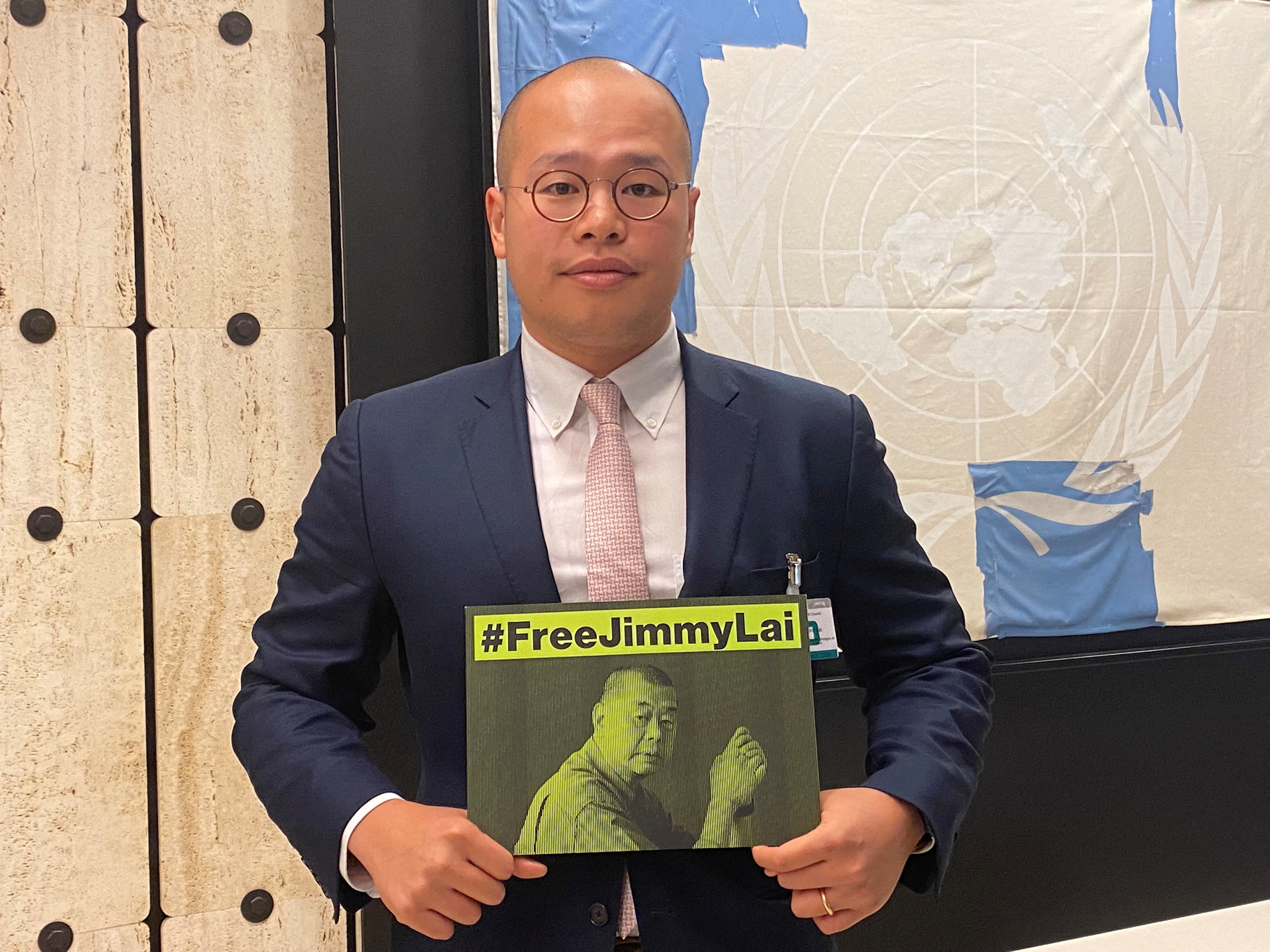 Sebastien Lai, son of Hong Kong media tycoon Jimmy Lai, holds a sign calling for the release of his father