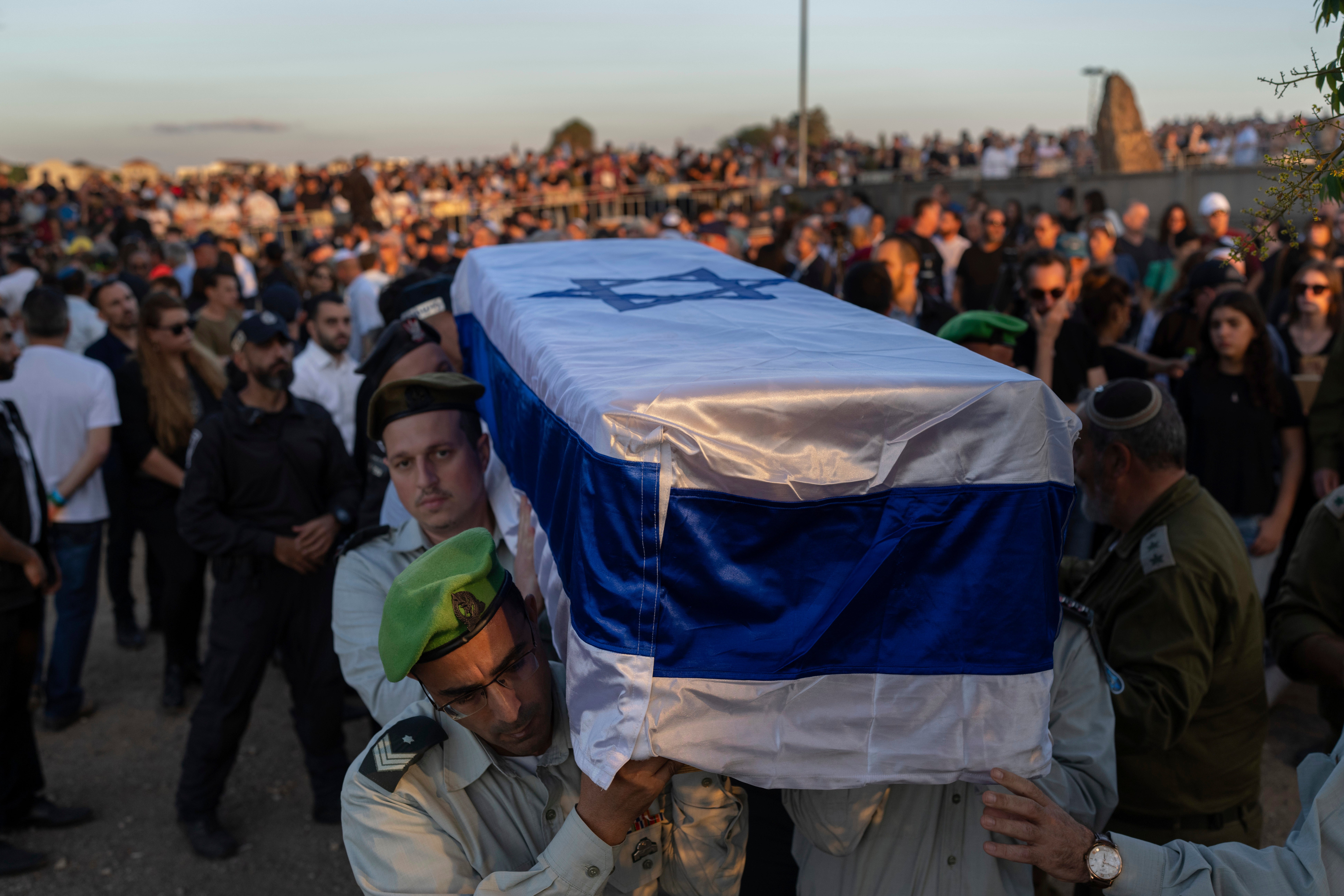 Israeli soldiers carry a coffin during the funeral of the head of the Sha’ar Hanegev Regional Council, Ofir Lipstein, who was killed by Hamas militants