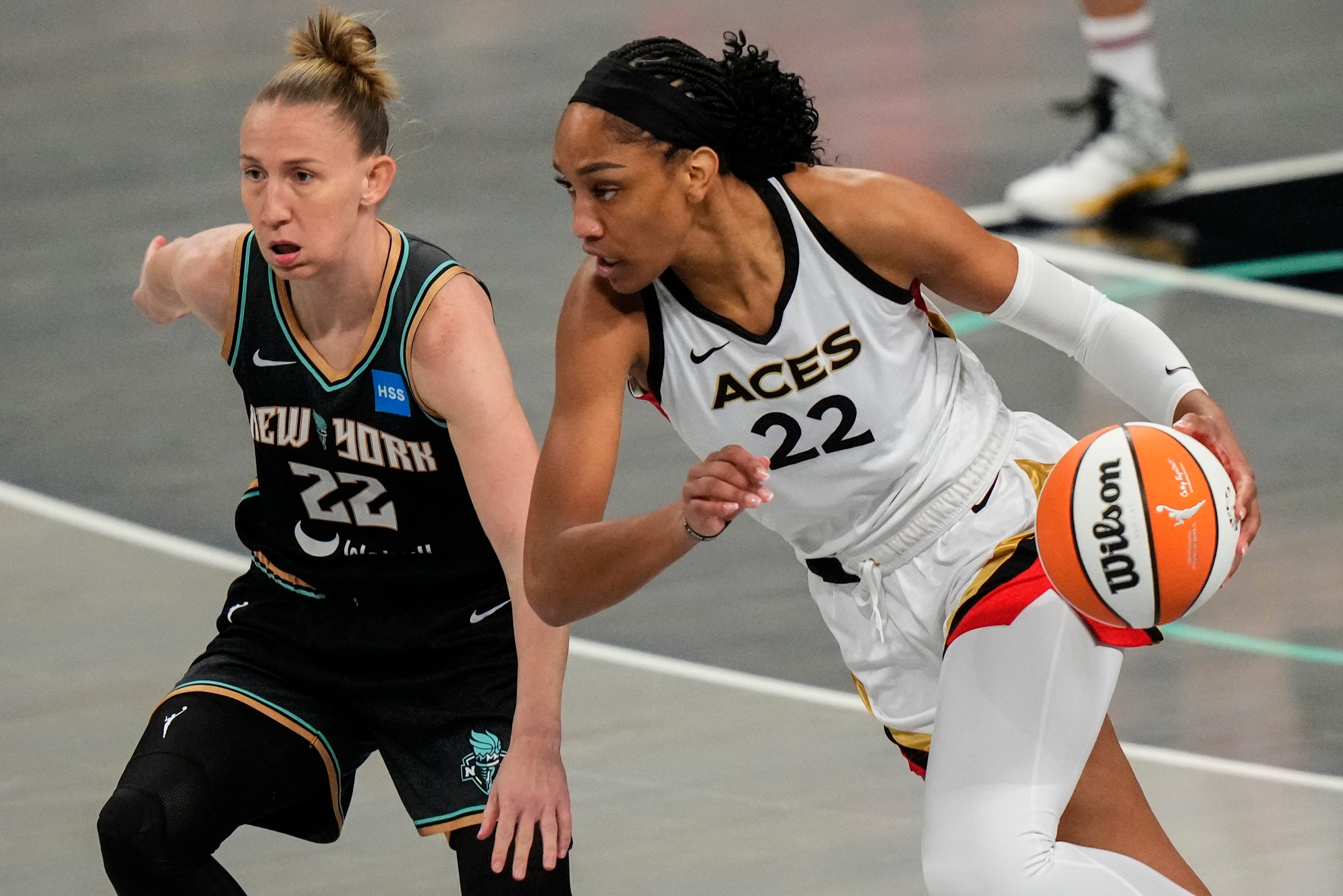 Las Vegas Aces’ Aja Wilson, right, drives past New York Liberty’s Courtney Vandersloot (Frank Franklin II/AP