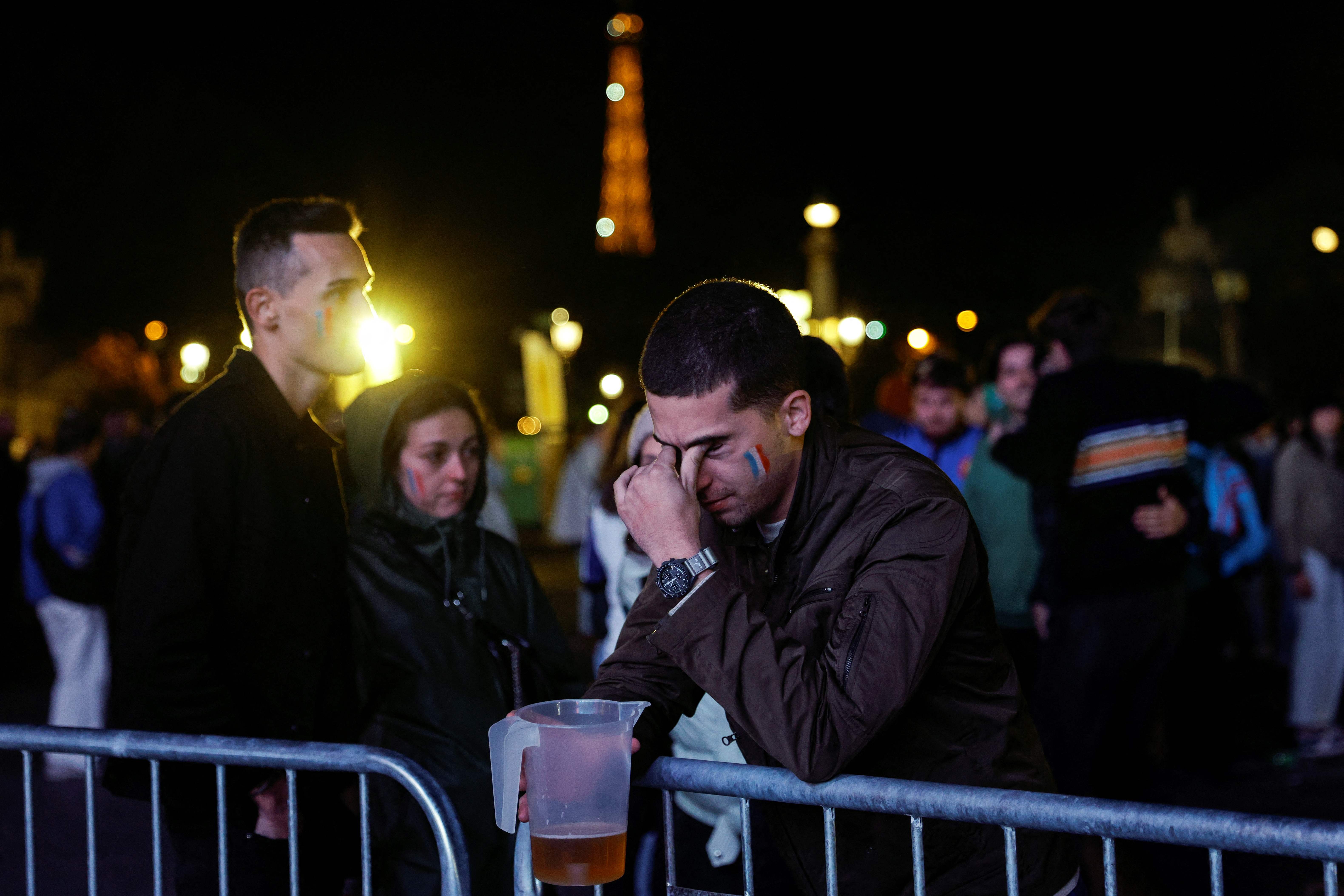 A supporter reacts at a fanzone on Place de la Concorde in Paris