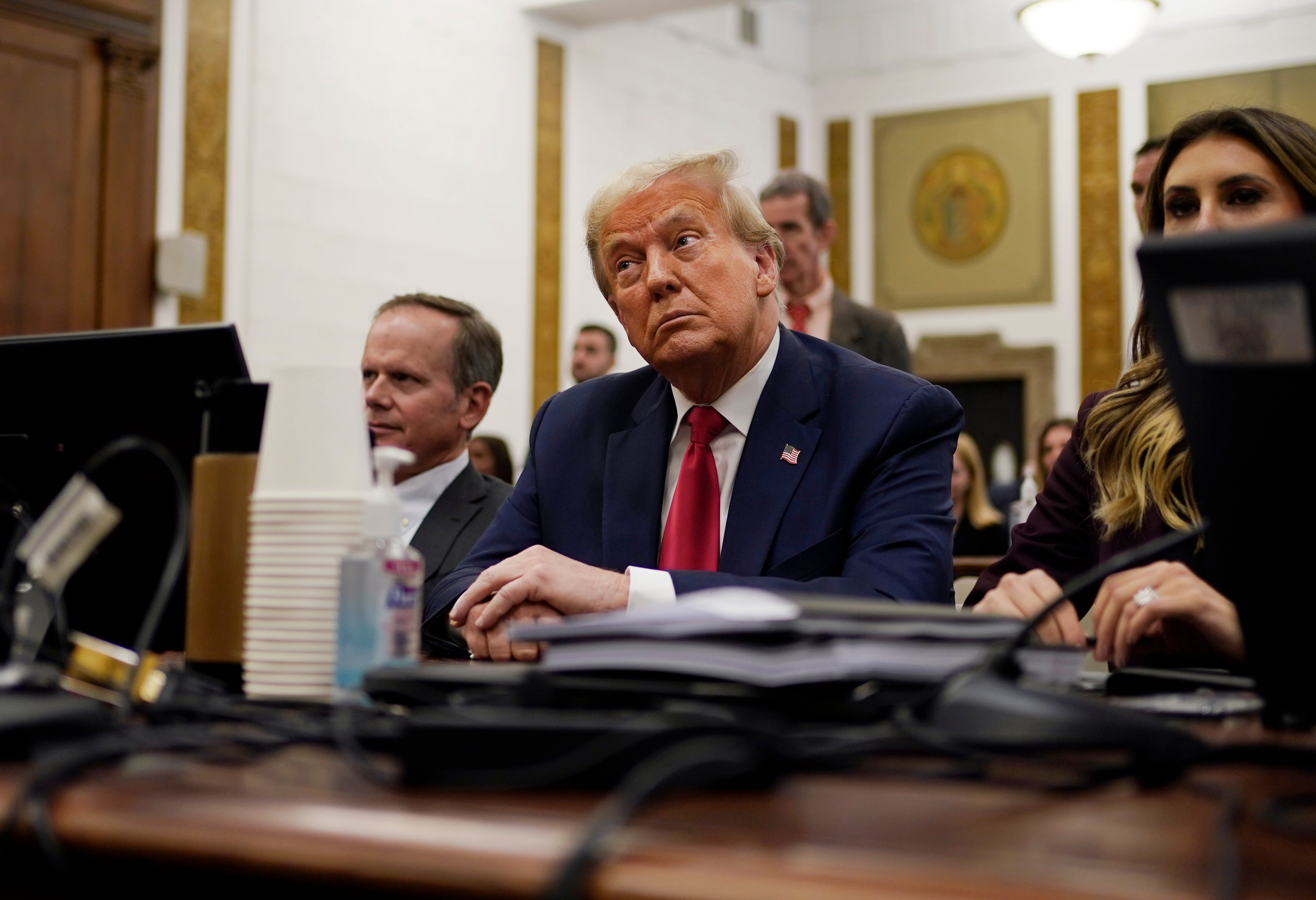 Former President Donald Trump sits in the courtroom with his legal team