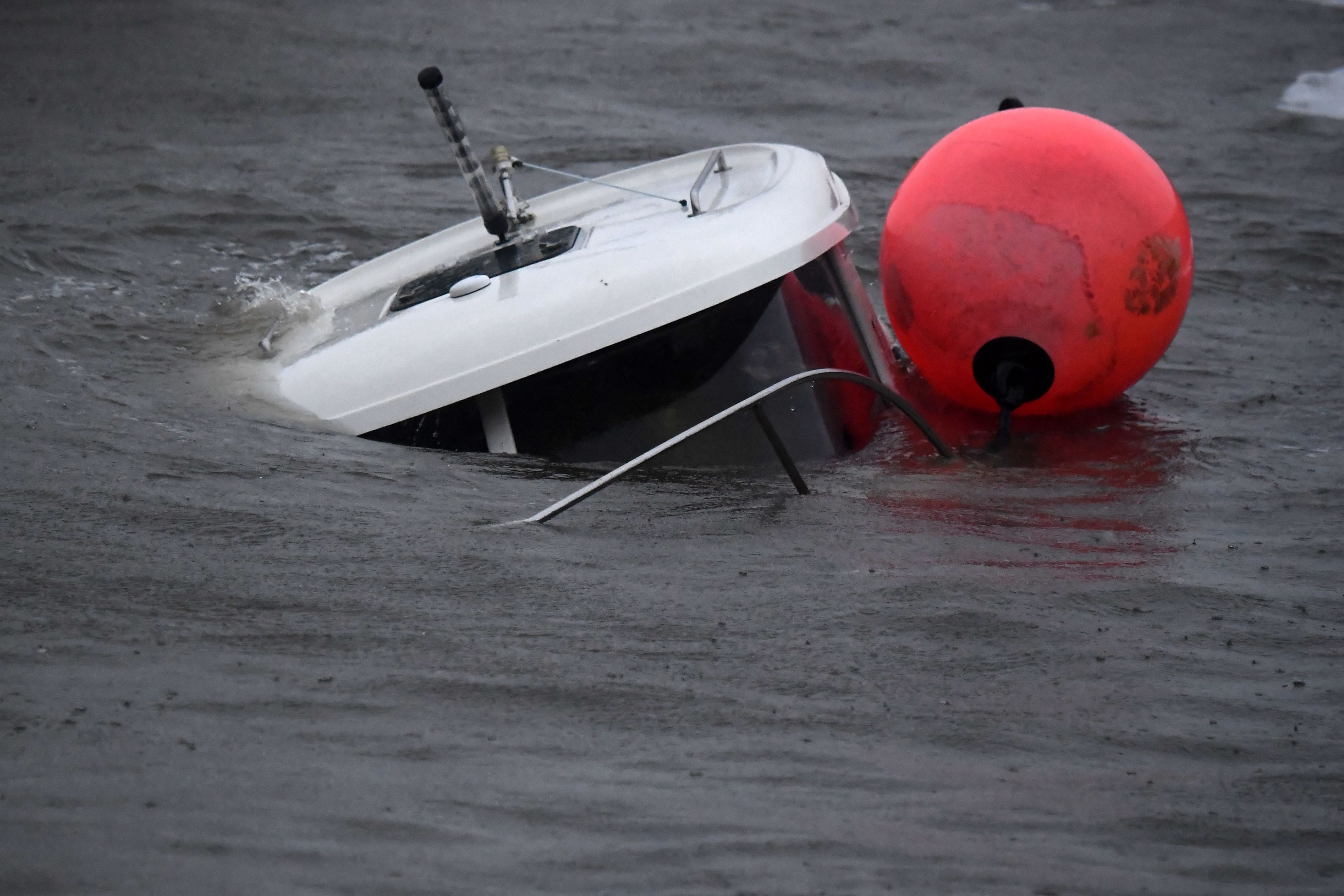 A boat sinks inside the harbour in Stonehaven on the east coast of Scotland