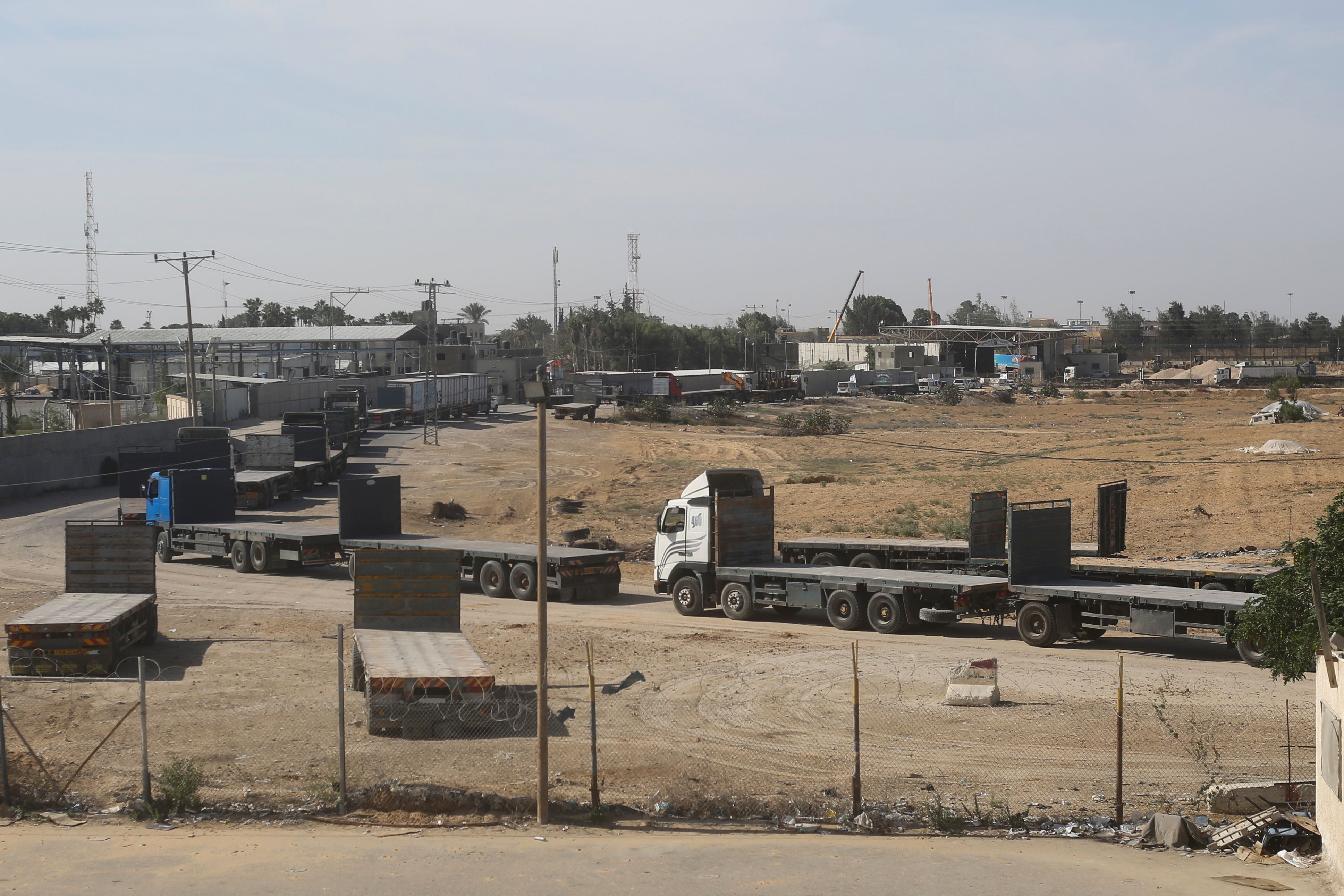 Palestinian trucks line up on the border to take humanitarian aid In Rafah (Hatem Ali/AP)