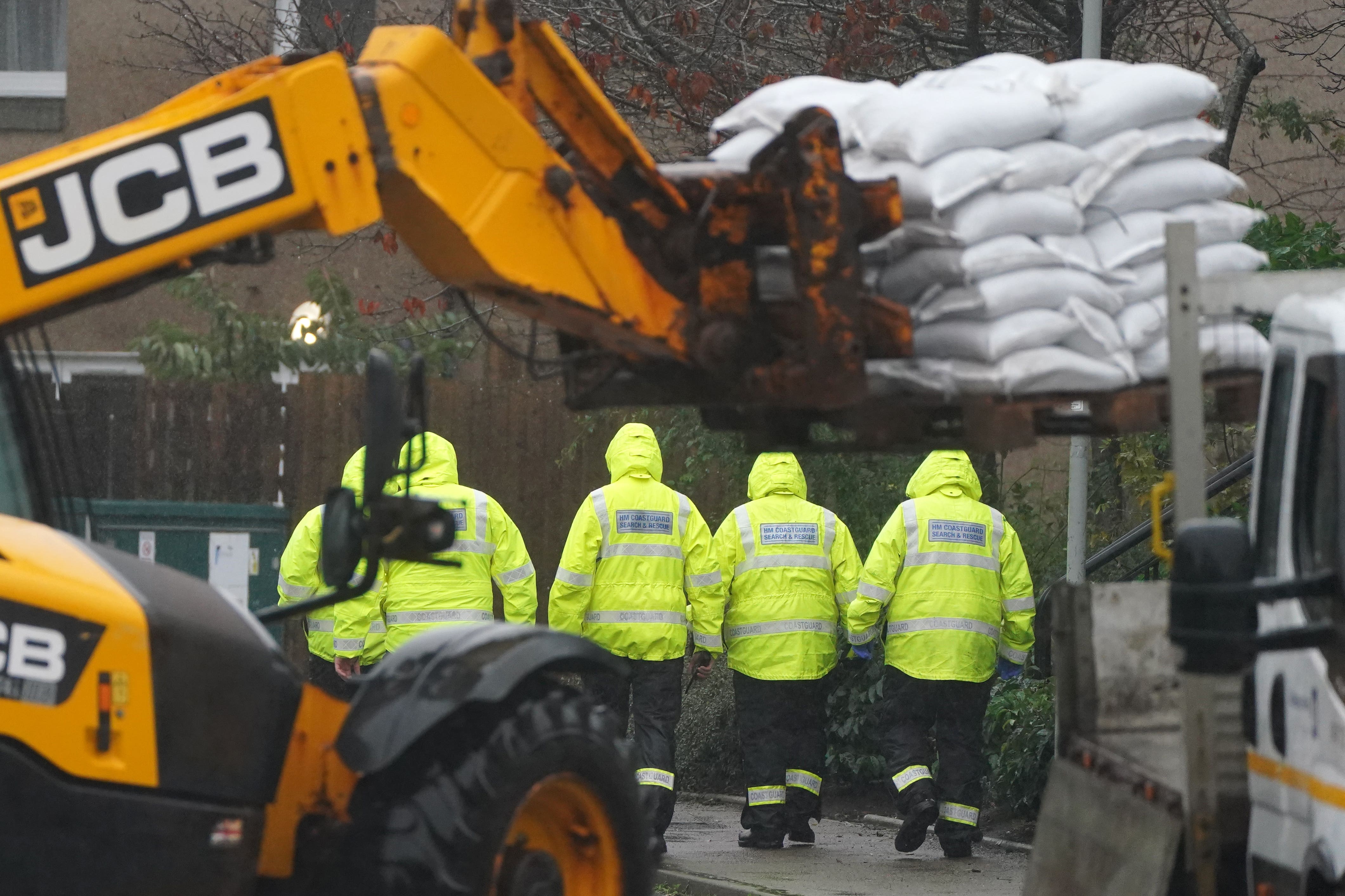 Emergency services go door to door speaking with residents and assist with putting out sandbags in Aberdeenshire (Andrew Milligan/PA)