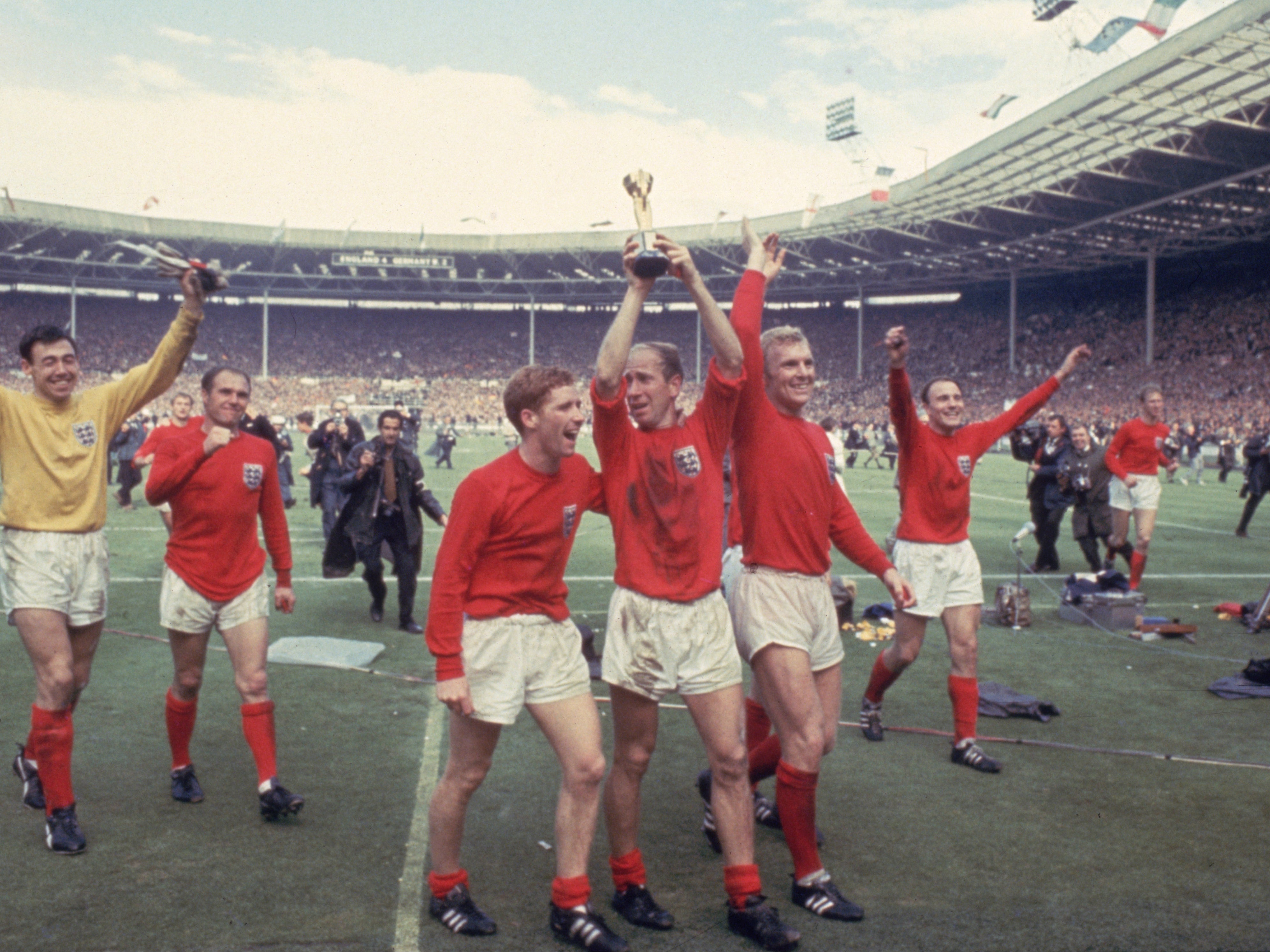 Bobby Charlton, centre, celebrates with the World Cup at Wembley