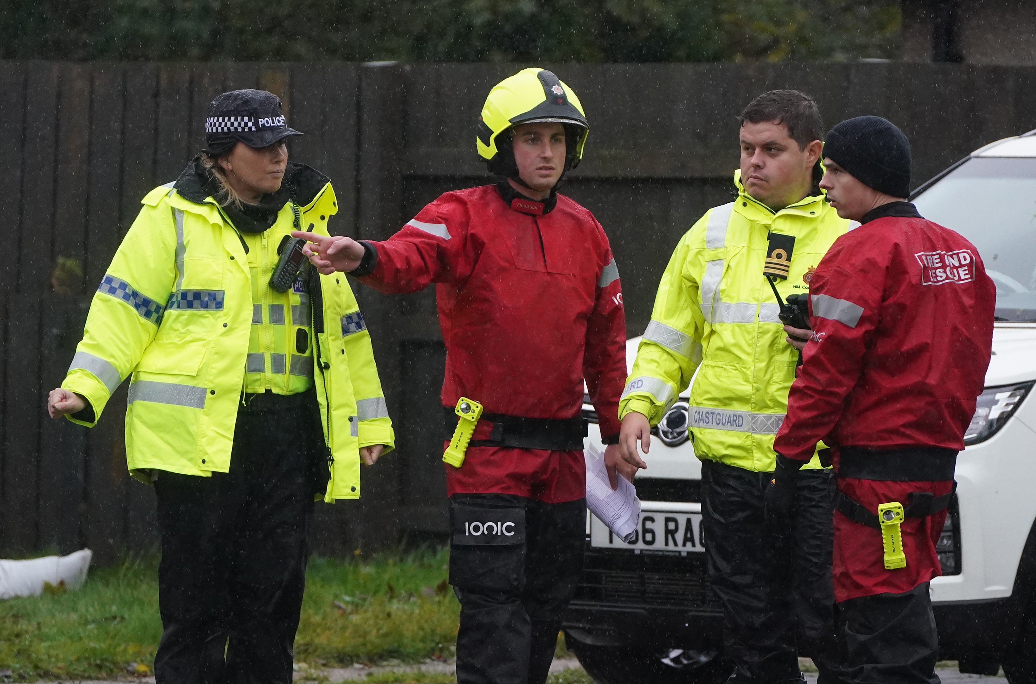 Emergency services go door to door speaking with residents and assist with putting out sandbags in Canal Road in Inverurie, Aberdeenshire