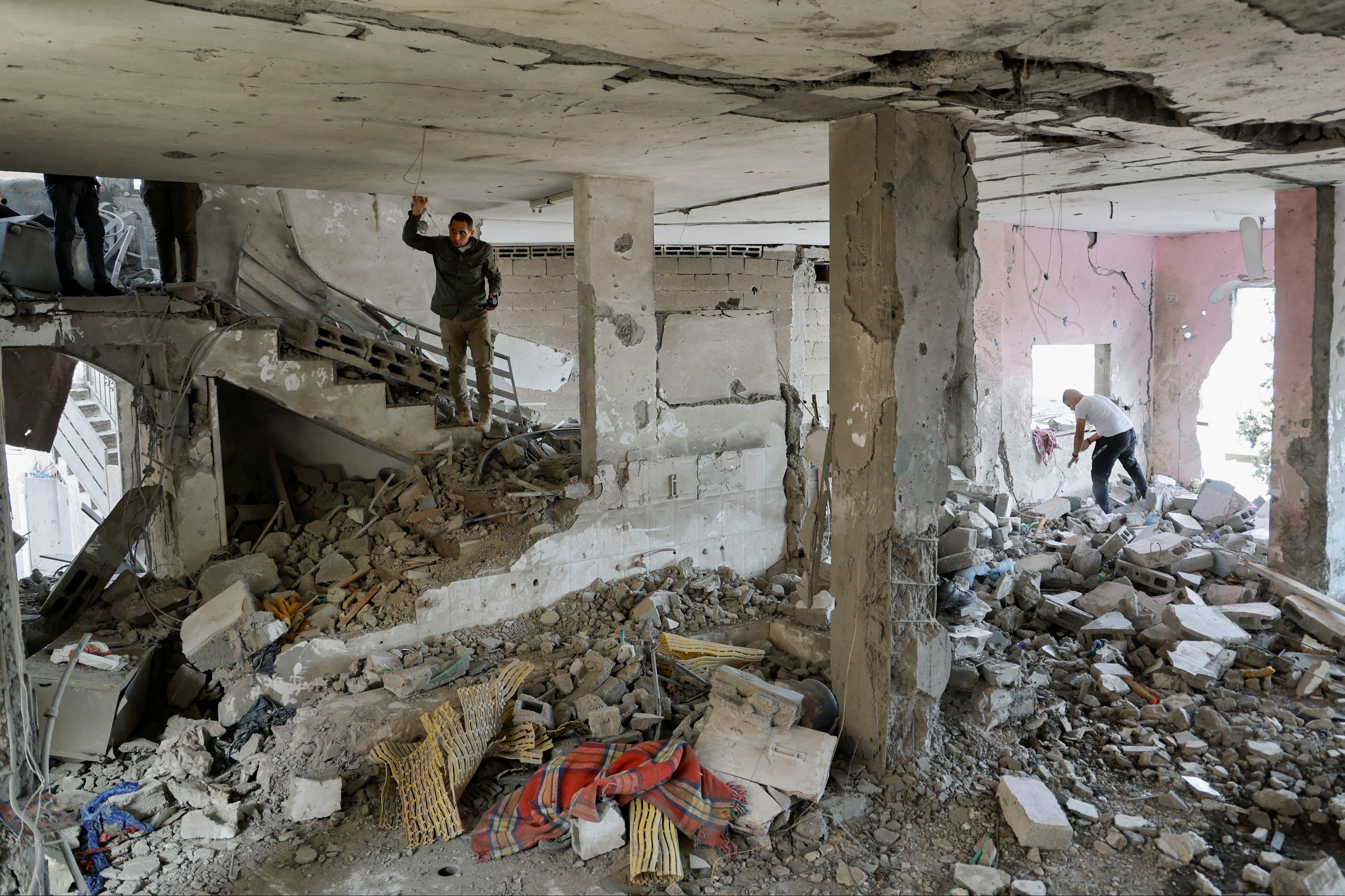 Palestinians check the damage inside a mosque which was hit in an Israeli air strike, in Jenin refugee camp in the Israeli-occupied West Bank