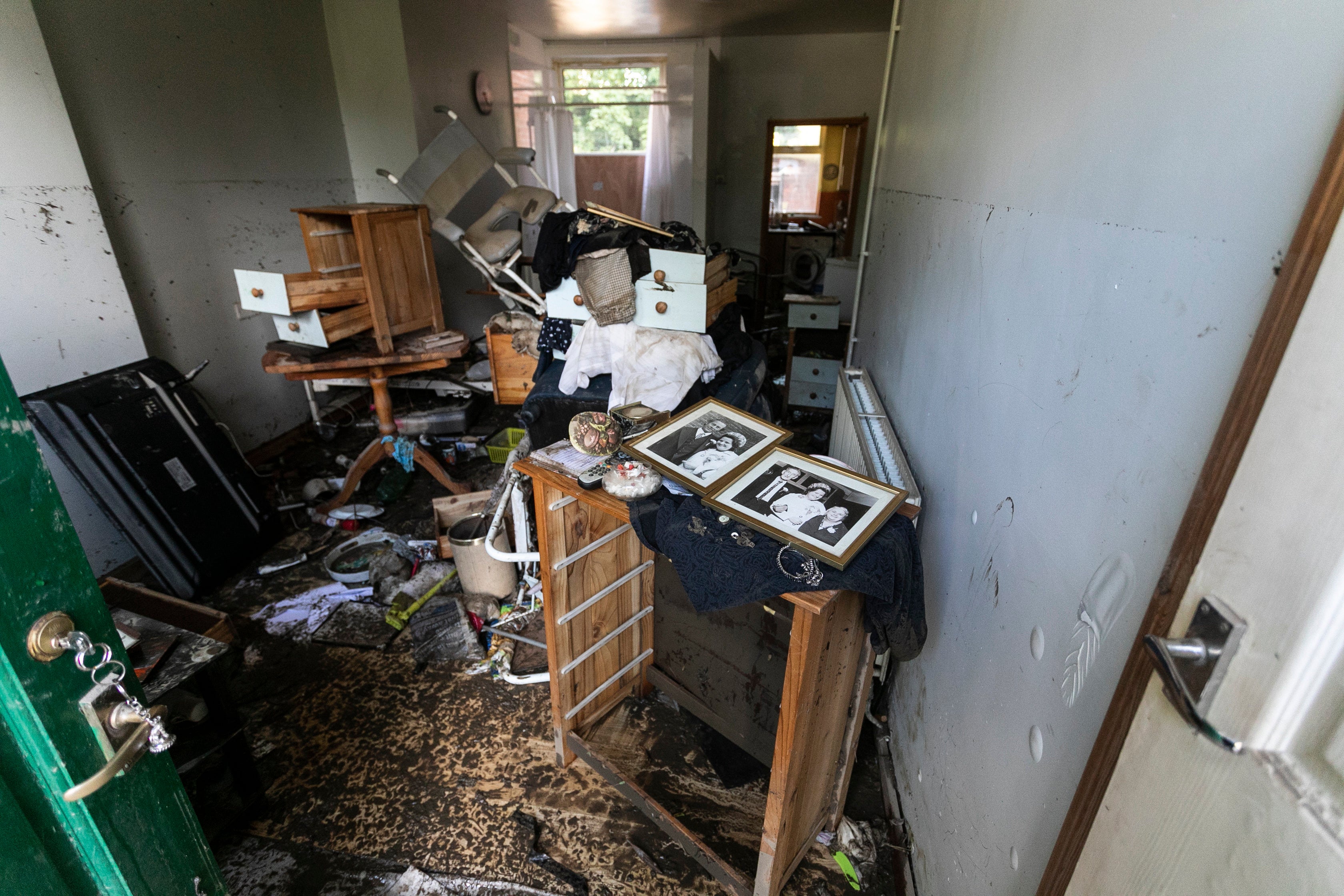 Flood high tide marks are seen over 5 foot high in the front room of Maureen Gilbert