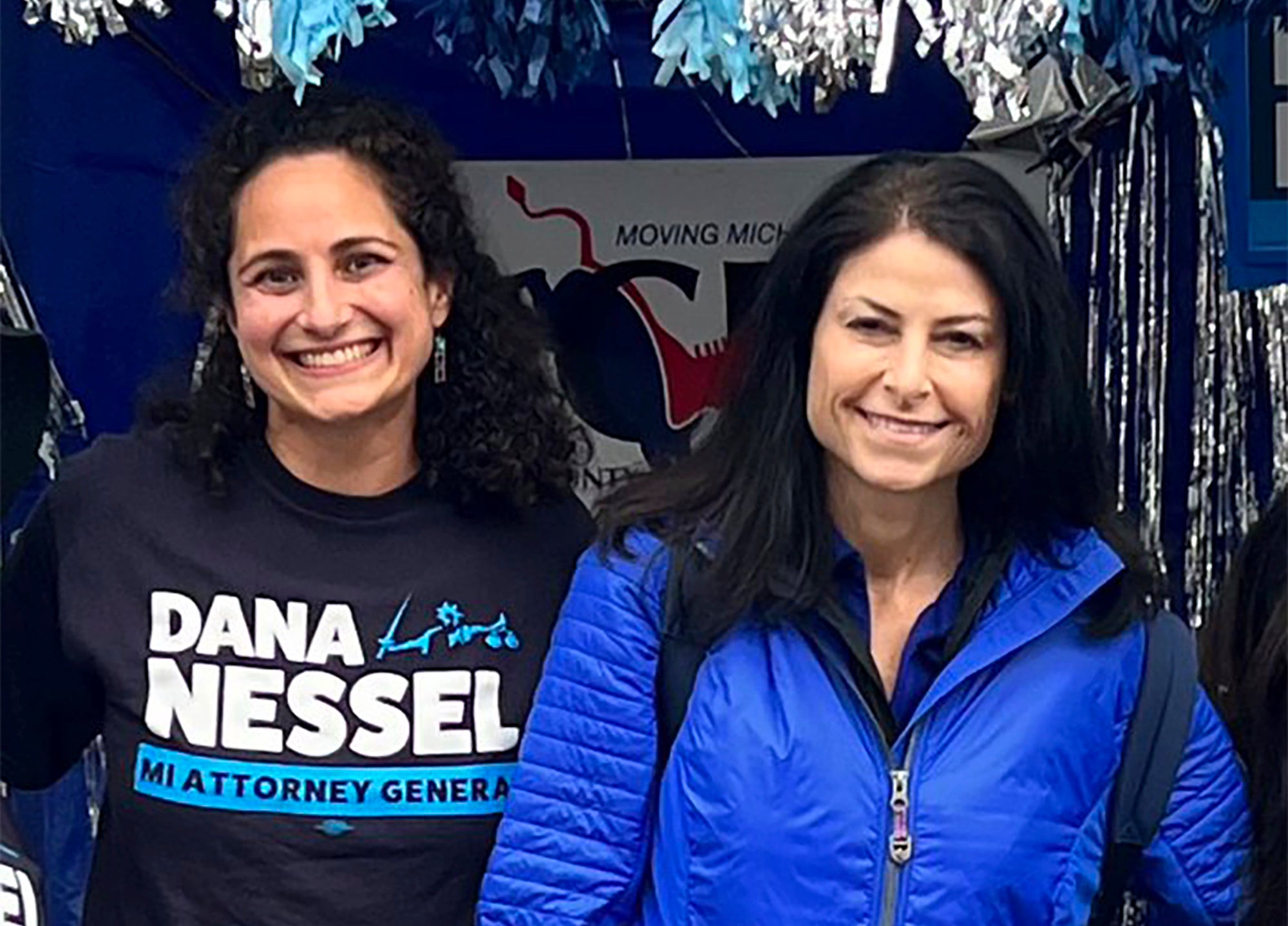 In this photo released by Kimberly Bush, Samantha Woll, left, poses with Michigan Attorney General Dana Nessel on 4 September, 2022