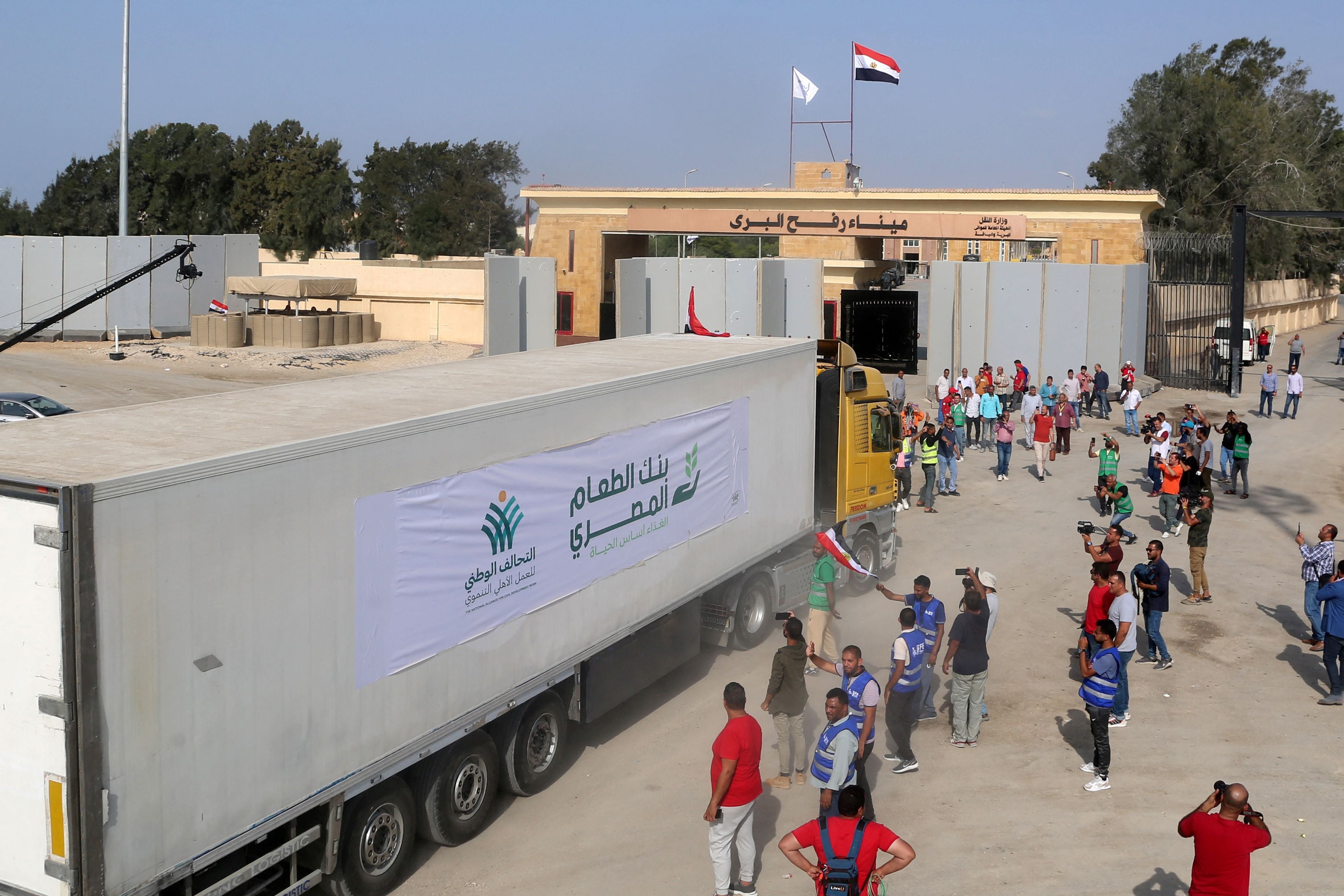 A truck caravan carries aid into Gaza through the Rafah border crossing with Egypt on 22 October