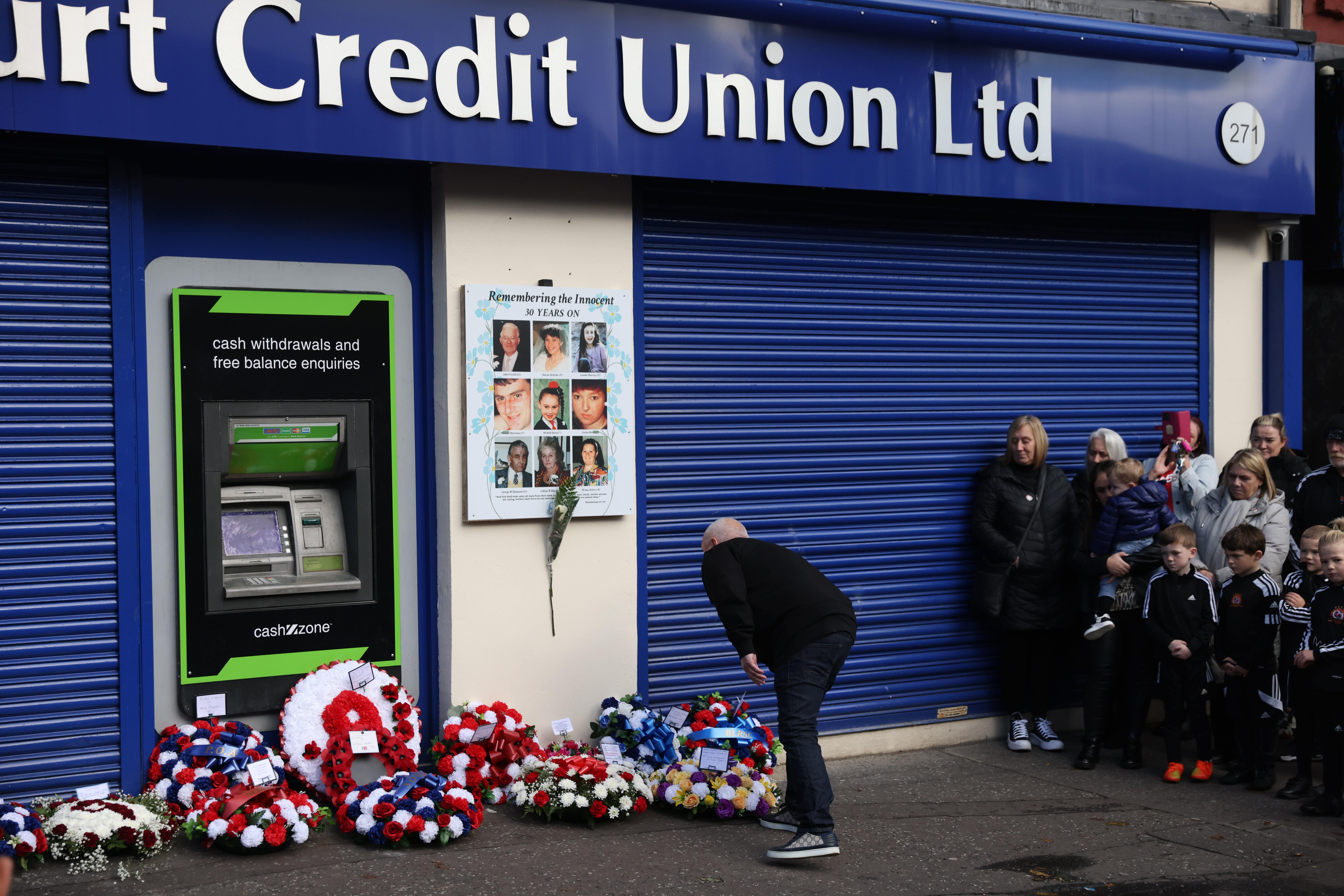 A person lays a wreath on Shankill Road in Belfast during an event ahead of the 30th anniversary of the Shankill bombing (Peter Morrison/PA)