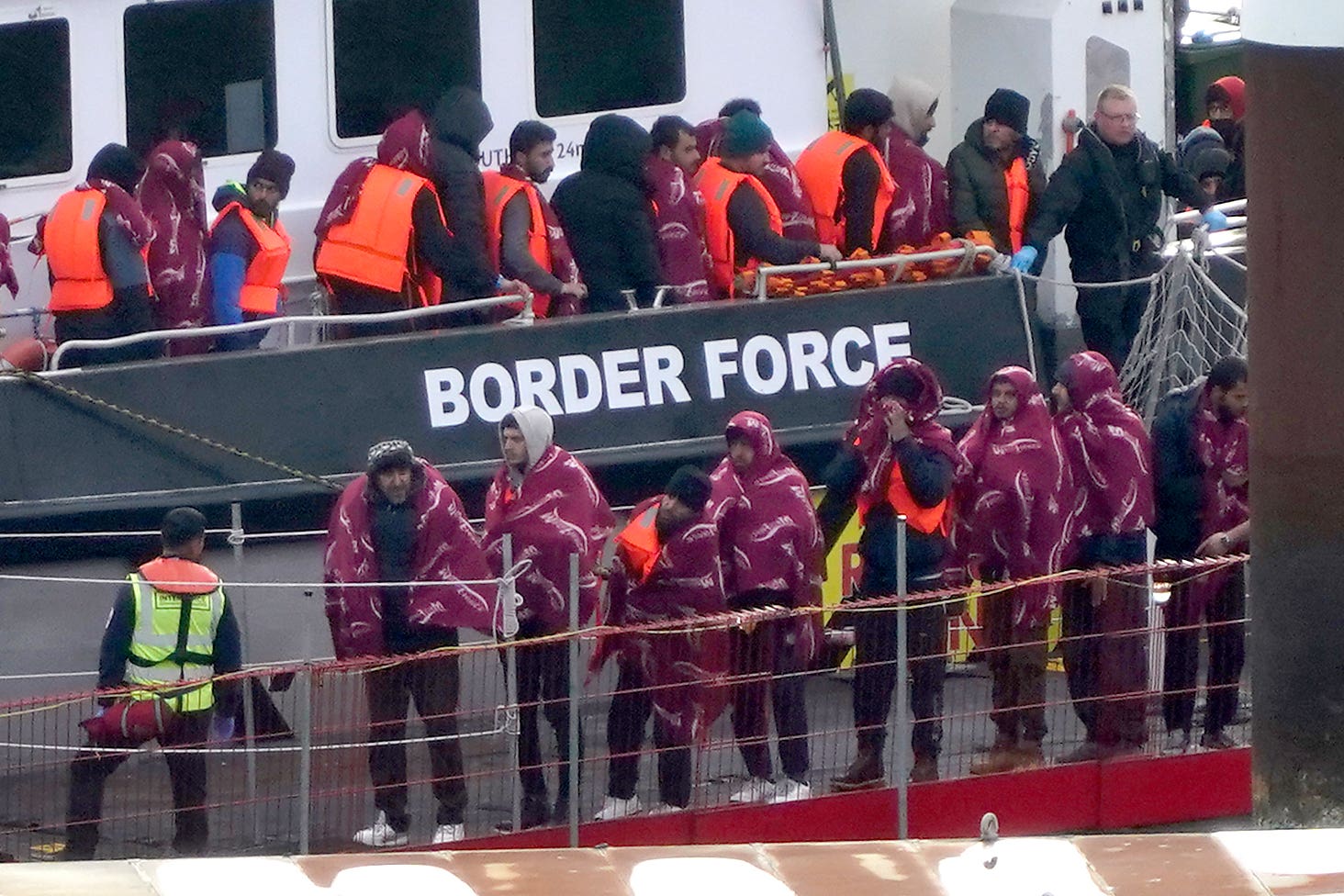 A group of people thought to be migrants are brought into Dover, Kent, following a small boat incident in the Channel (Gareth Fuller/PA)