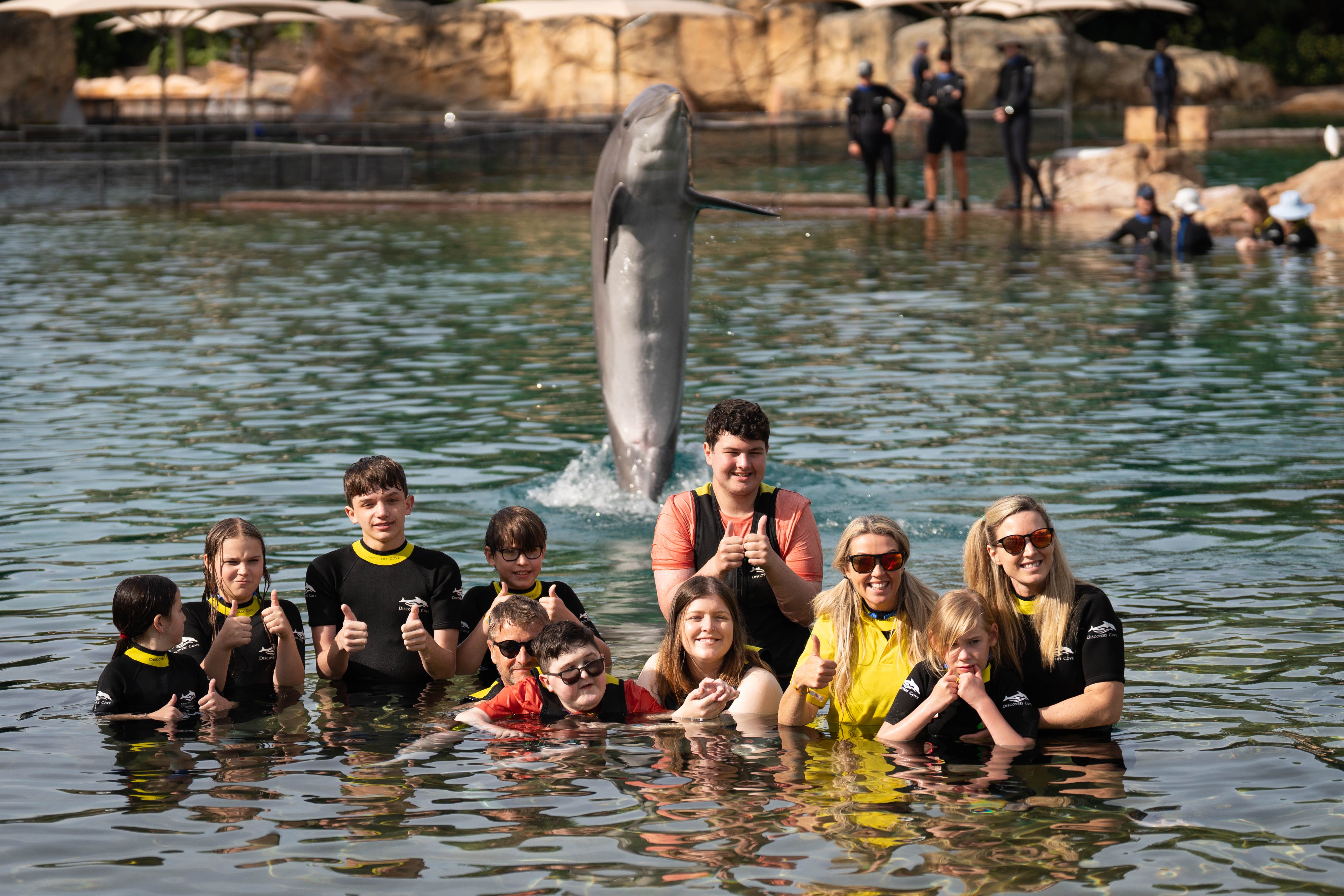 A file picture of children swim with dolphins during the a visit to Discovery Cove in Orlando, Florida (James Manning/PA)