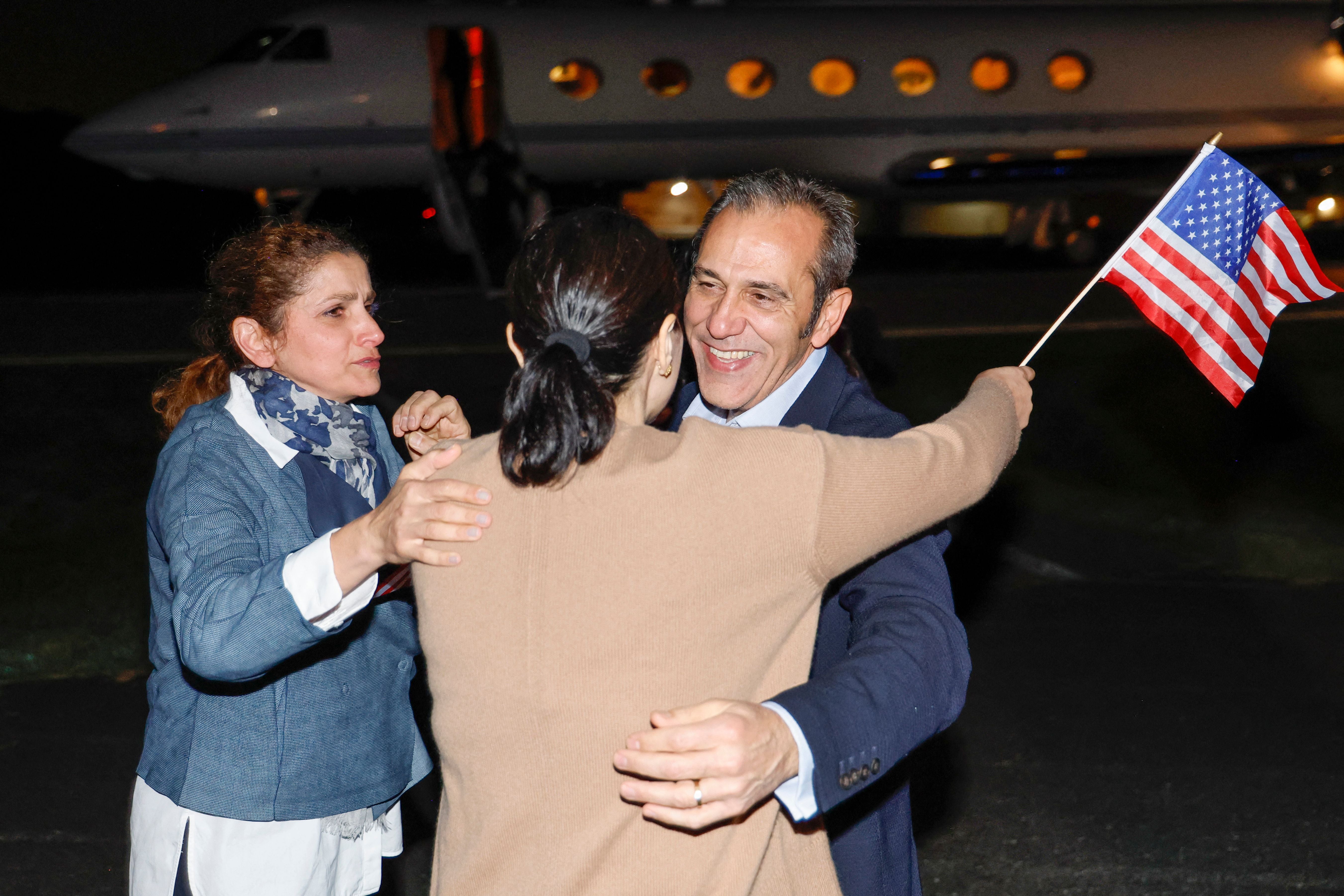 Family members embrace Emad Shargi, after he disembarks from an airplane at Davison Army Airfield at Fort Belvoir, Virginia