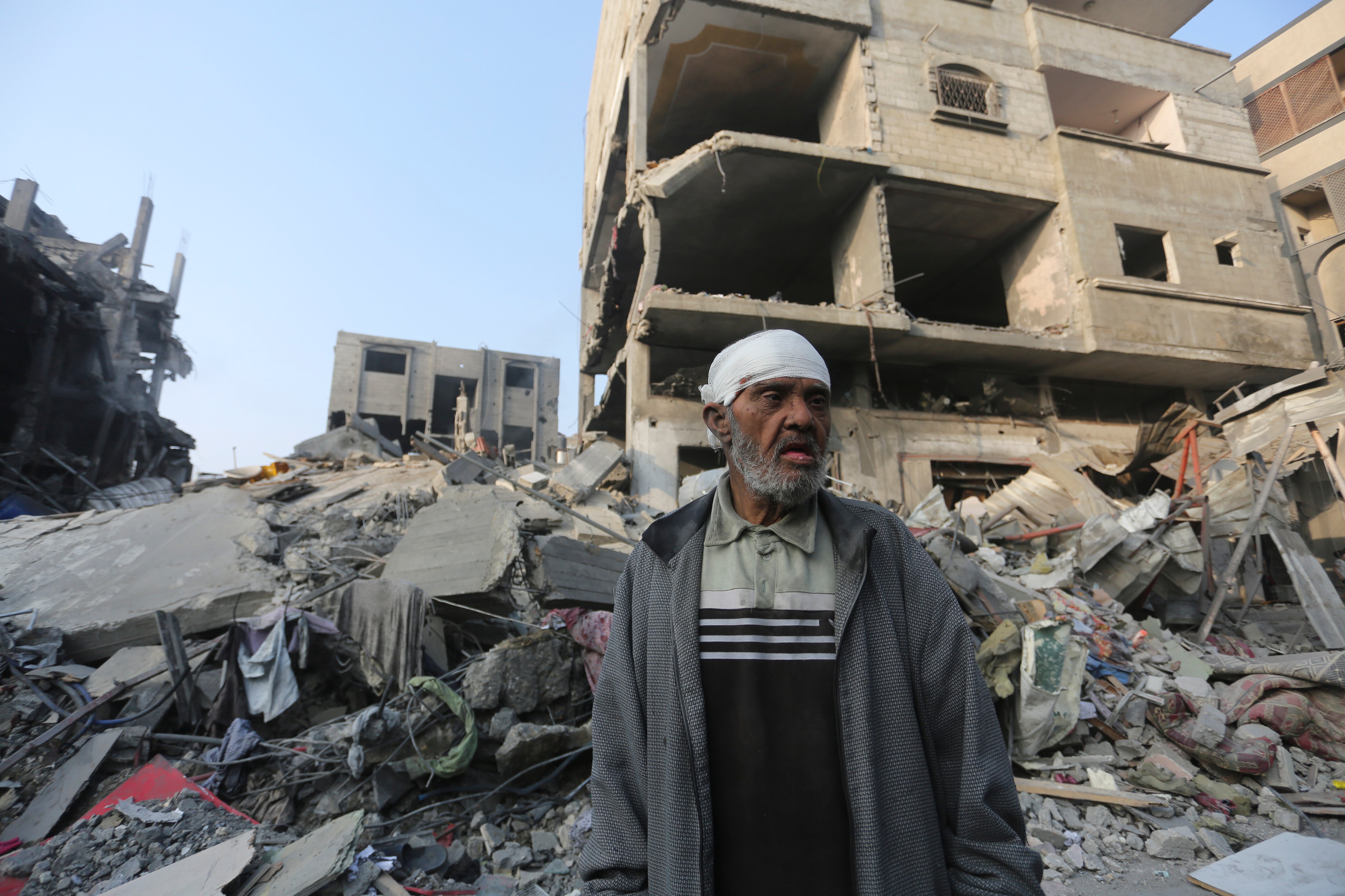 A Palestinian stands outside the building destroyed i the Israeli bombardment of the Gaza Strip in Rafah