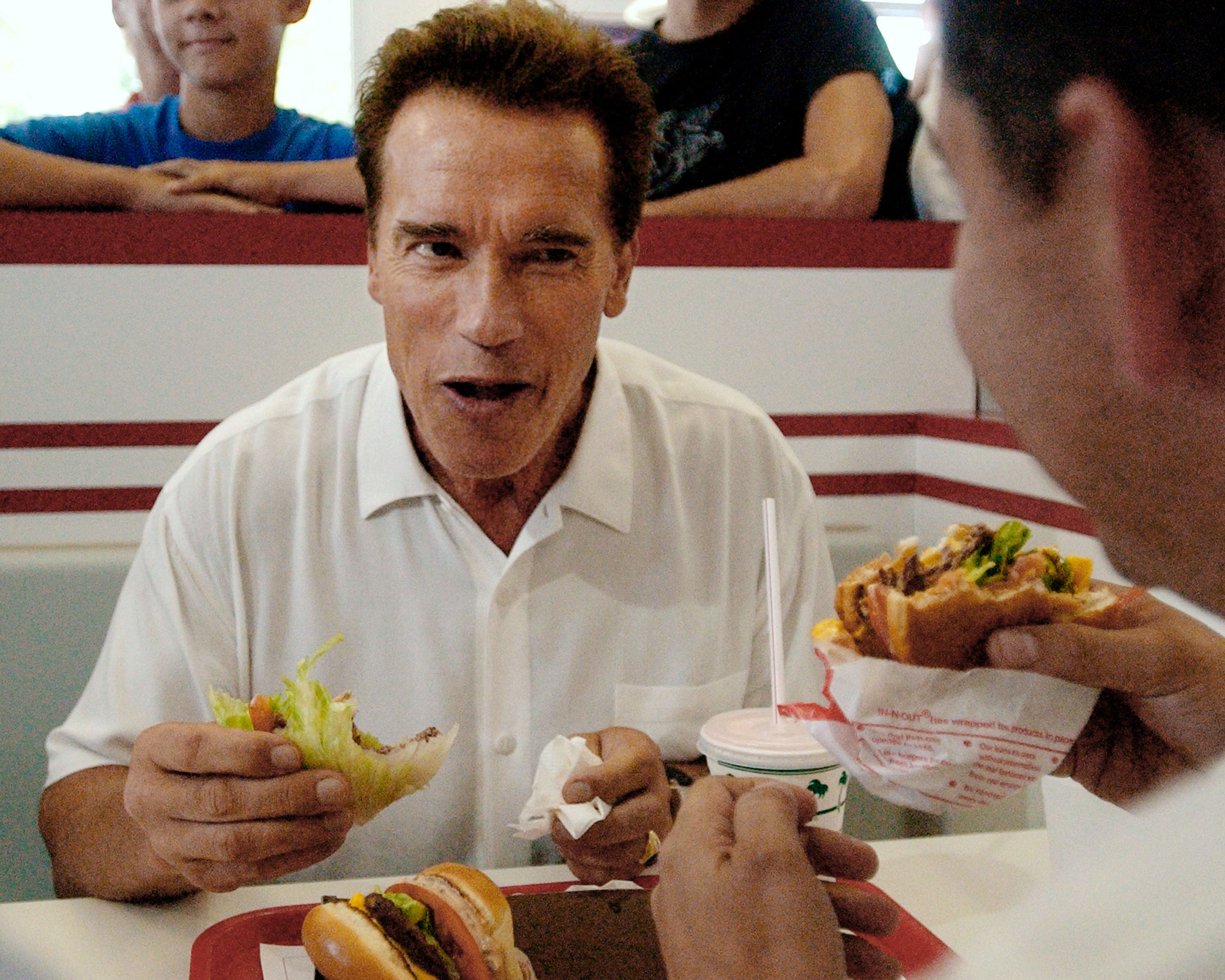 Focus, focus, focus: California gubernatorial candidate Arnold Schwarzenegger grabs a burger