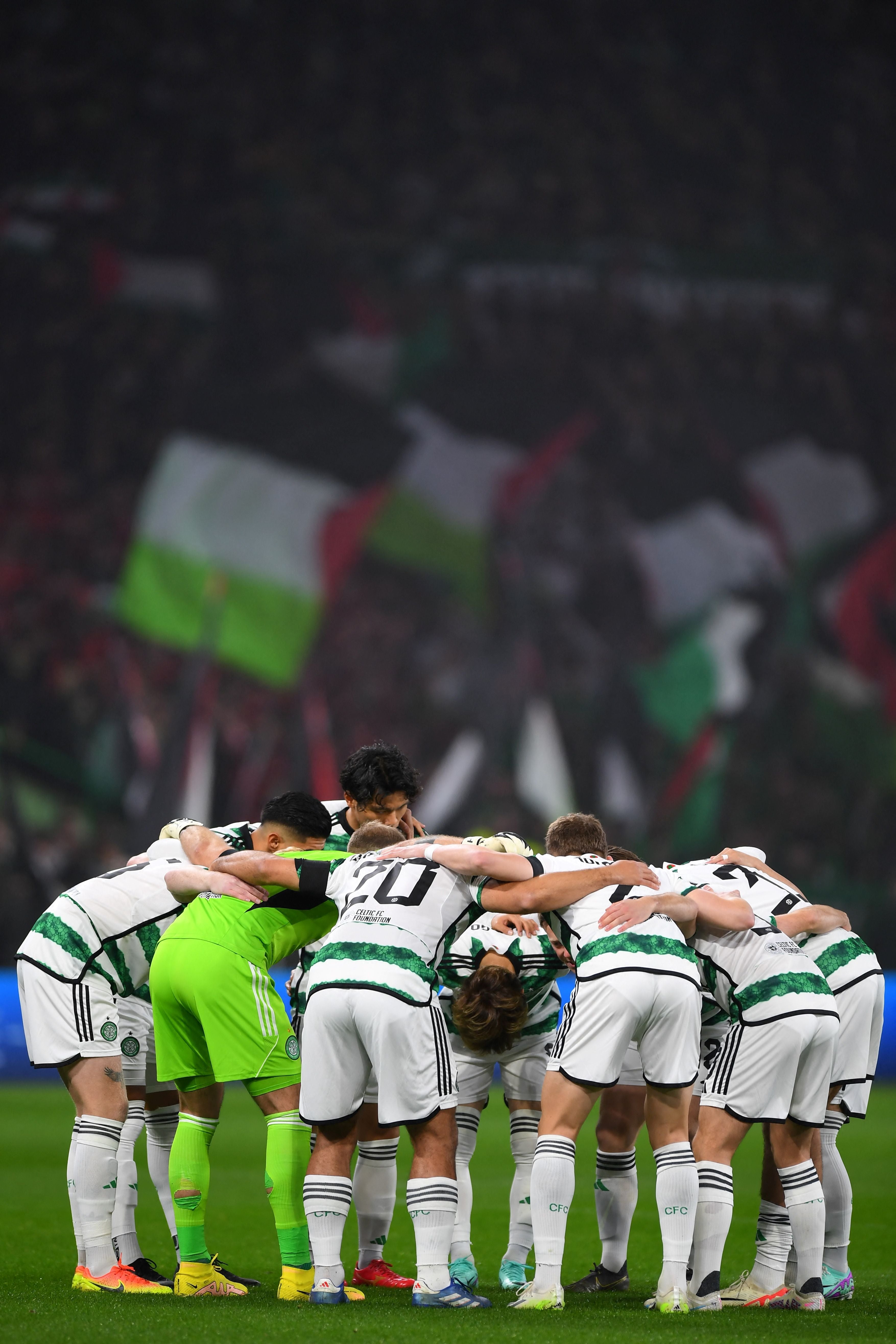 Supporters hold Palestinian flags at Celtic Park ahead of kick-off