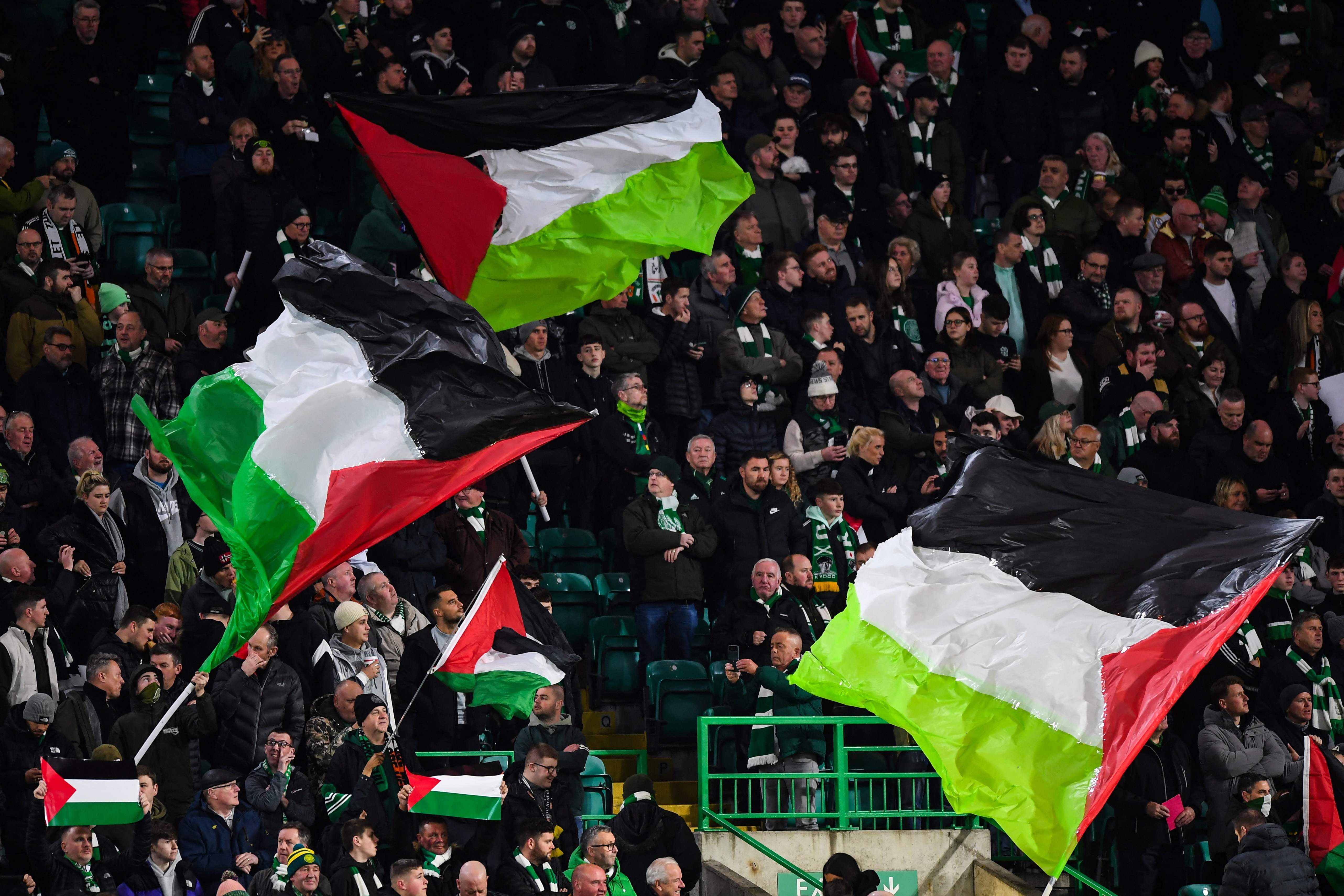 Supporters hold Palestinian flags at Celtic Park