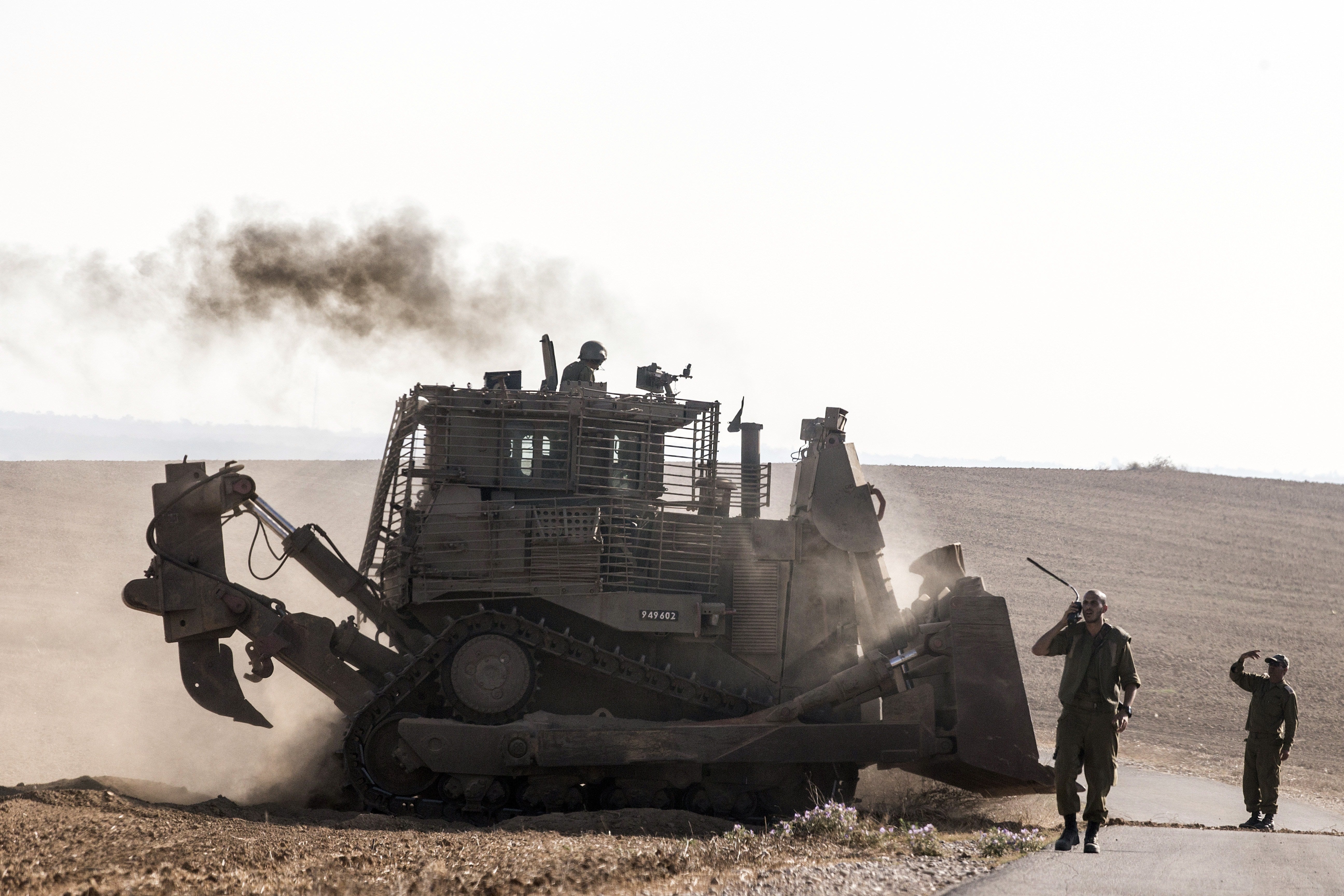 An Israeli D9 Bulldozer rolls along the southern Israeli border with the Gaza Strip