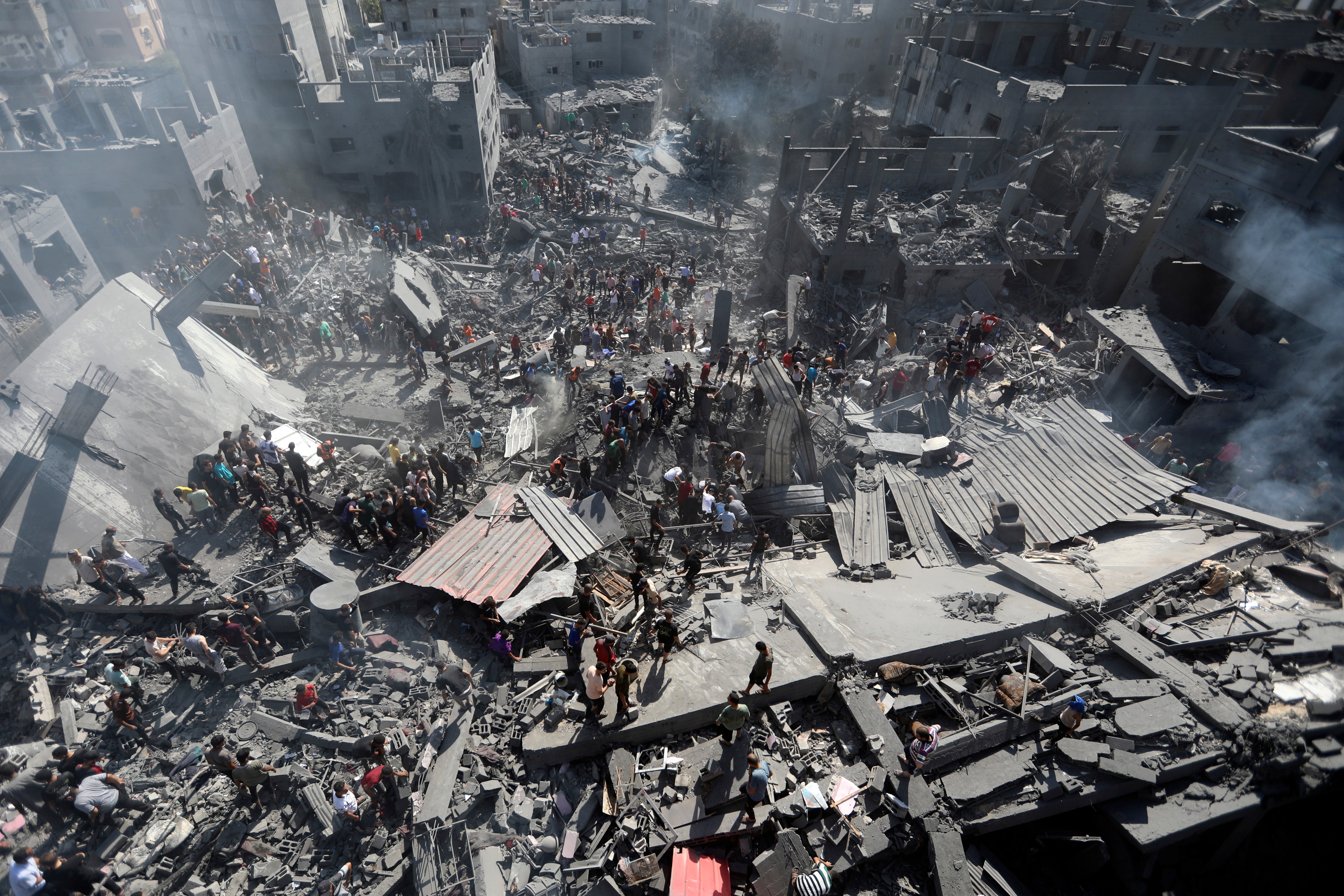 Palestinians inspect the rubble of destroyed buildings following Israeli airstrikes on town of Khan Younis, southern Gaza