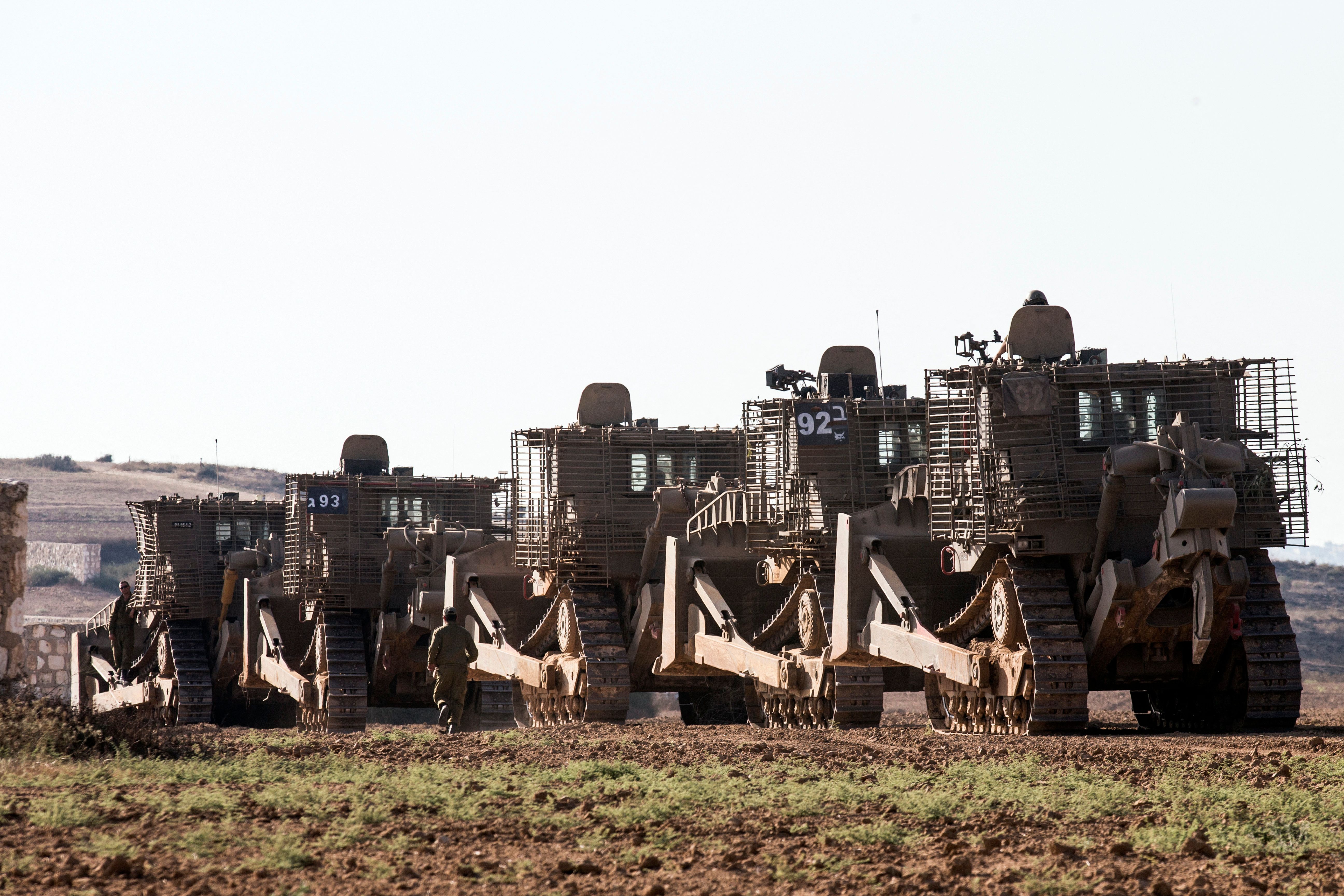 Israeli D9 bulldozers roll along the southern Israeli border with the Gaza Strip in 2014