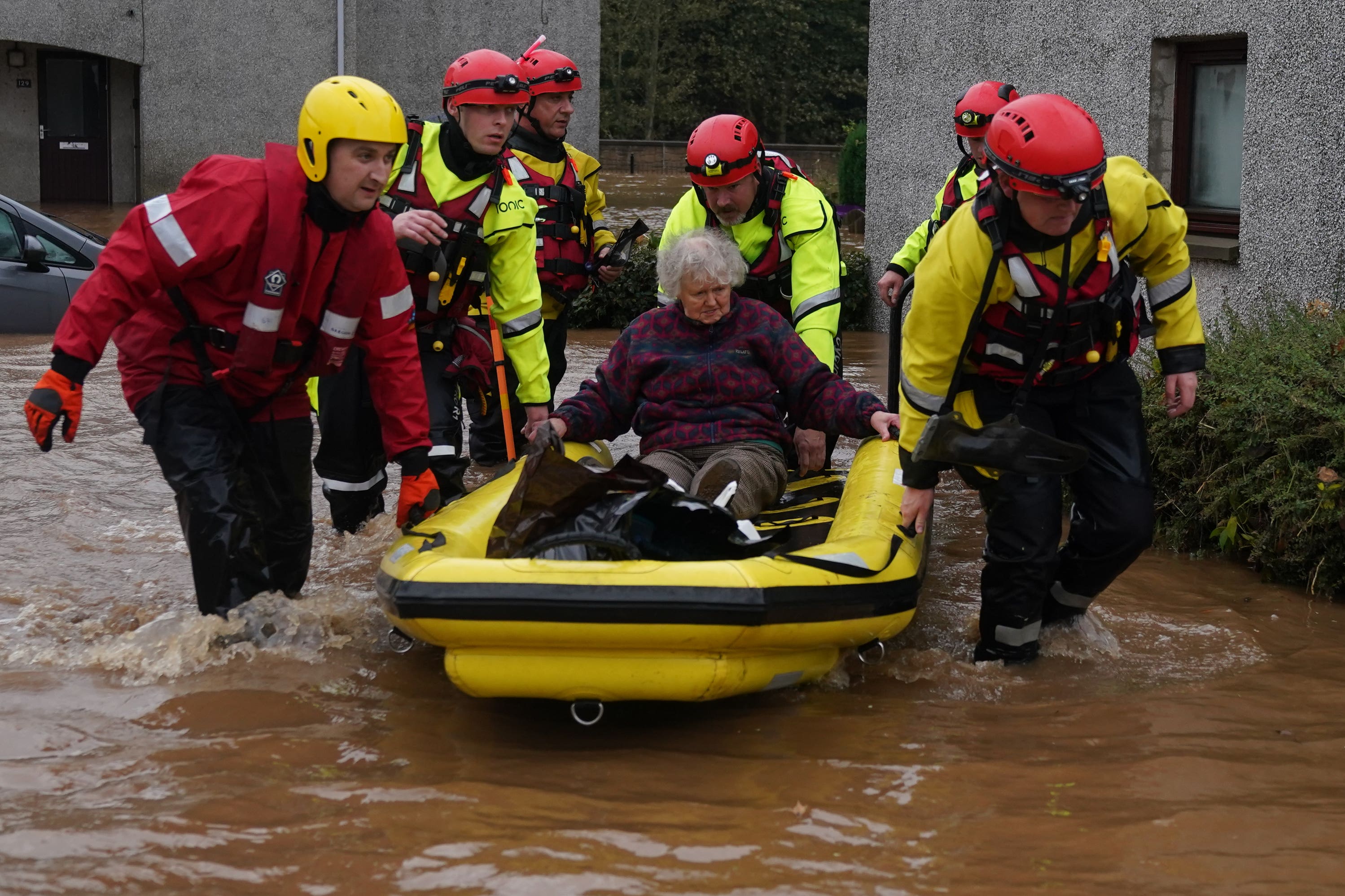 Members of the emergency services help local residents to safety in Brechin (PA)