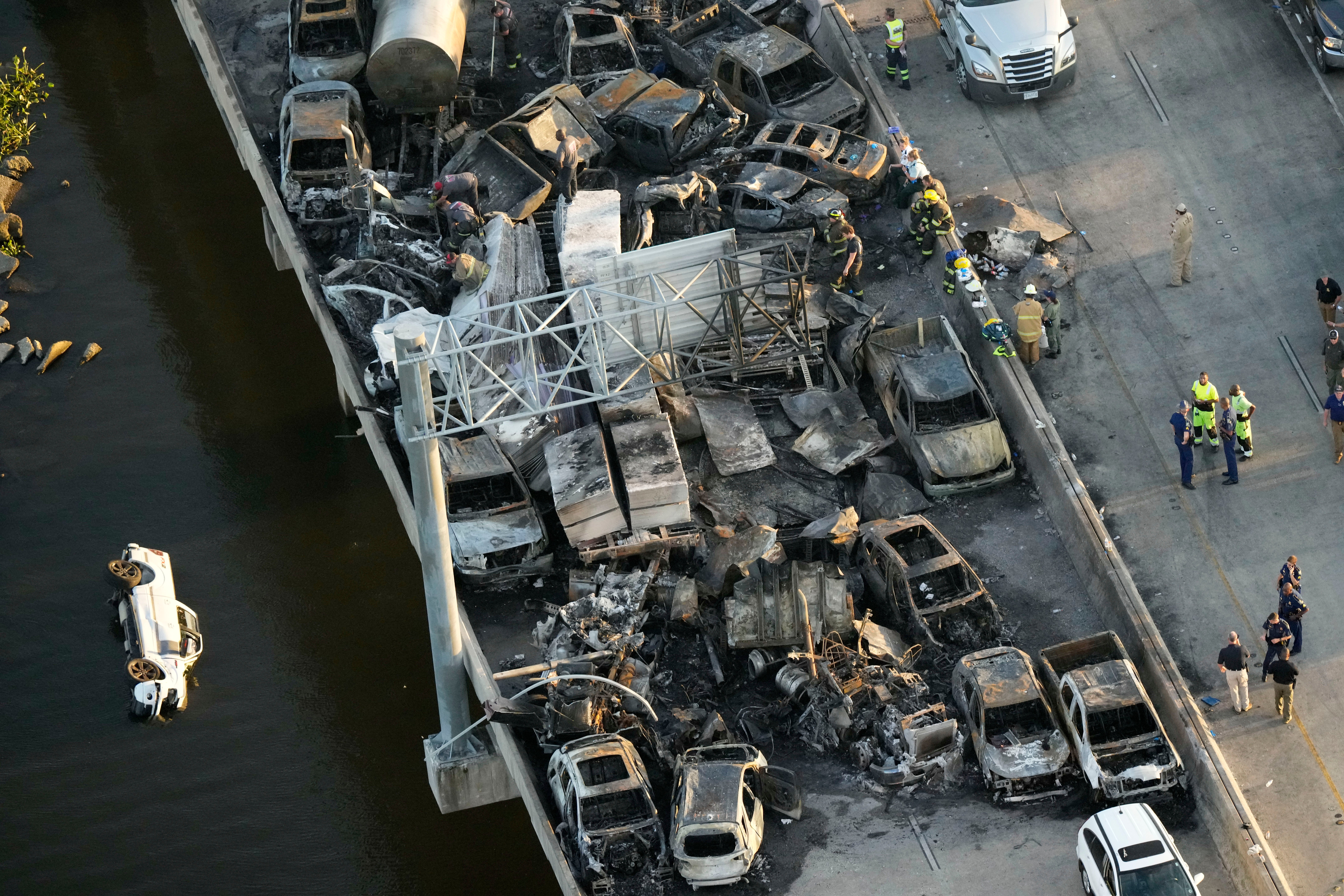 In this aerial photo, responders are seen near wreckage in the aftermath of a multi-vehicle pileup caused by ‘superfog’ on I-55 in Manchac, Louisiana