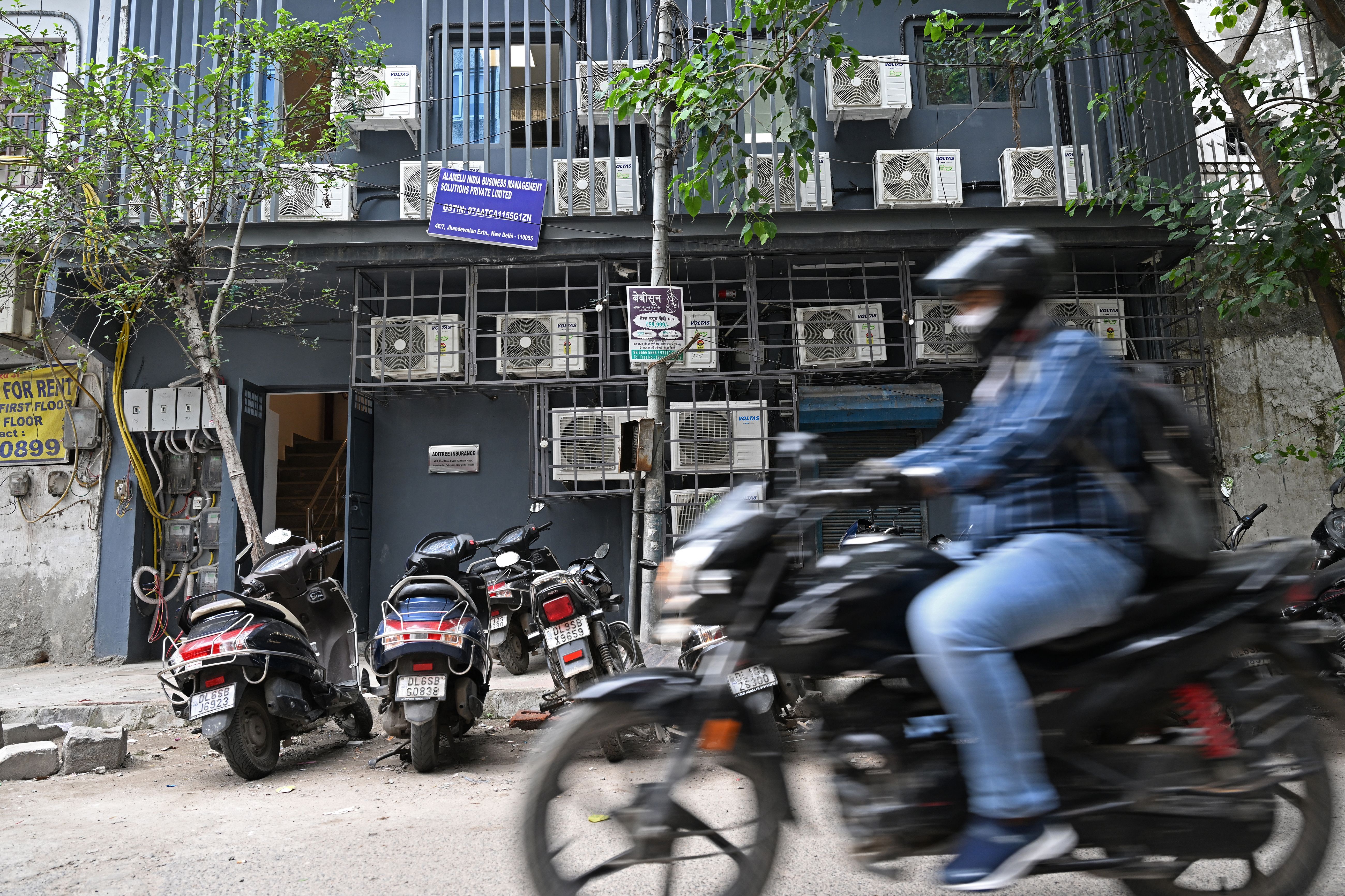 A commuter rides past a building with airconditioning units on its facade in New Delhi. India’s electricity consumption for household air conditioners is expected to increase nine-fold by 2050