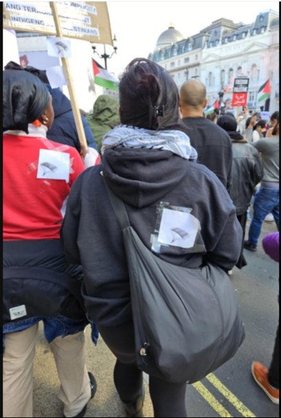 The paraglider signs stuck to the back of two women at the protest