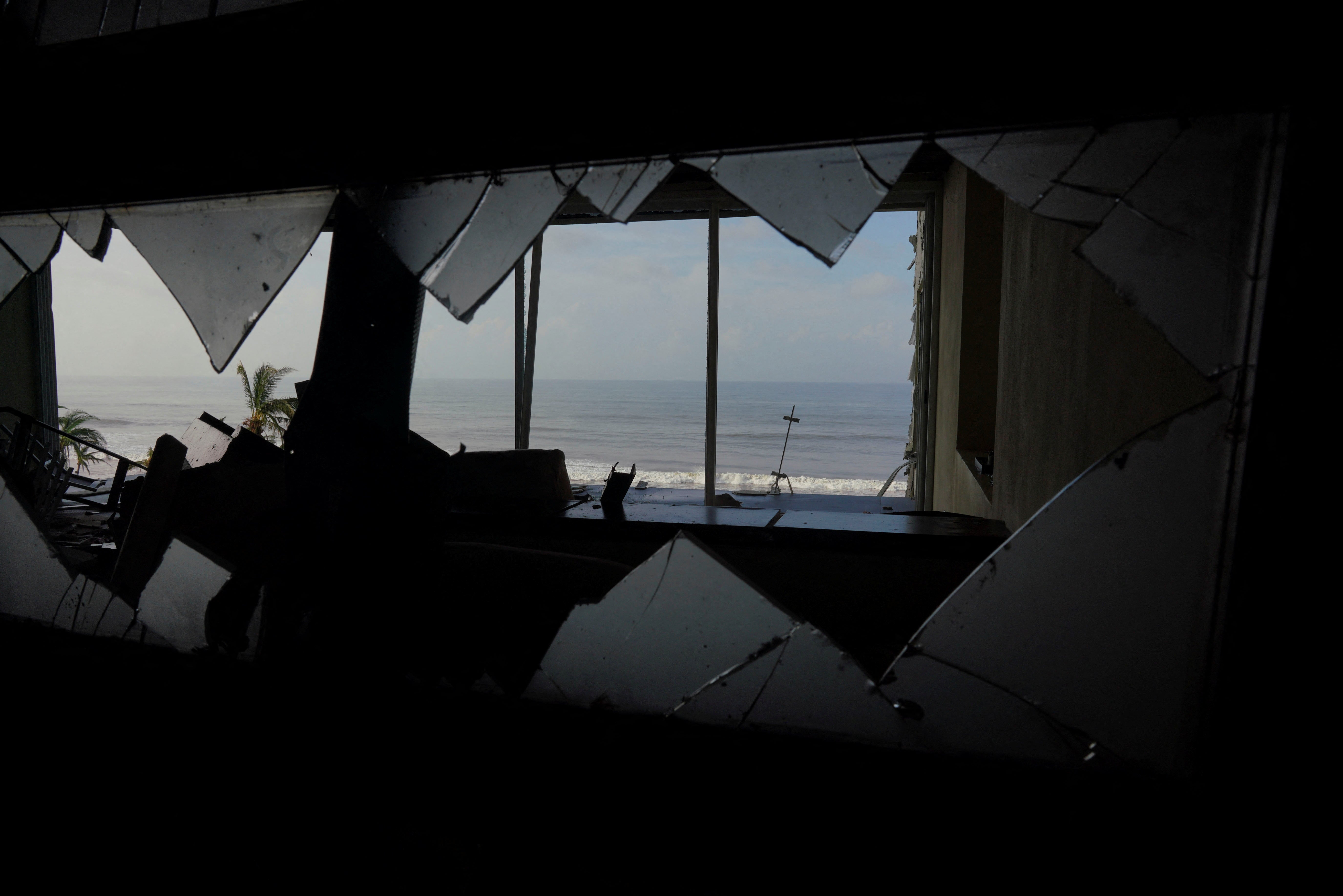 A view of the beach seen from inside a damaged hotel in the aftermath of Hurricane Otis