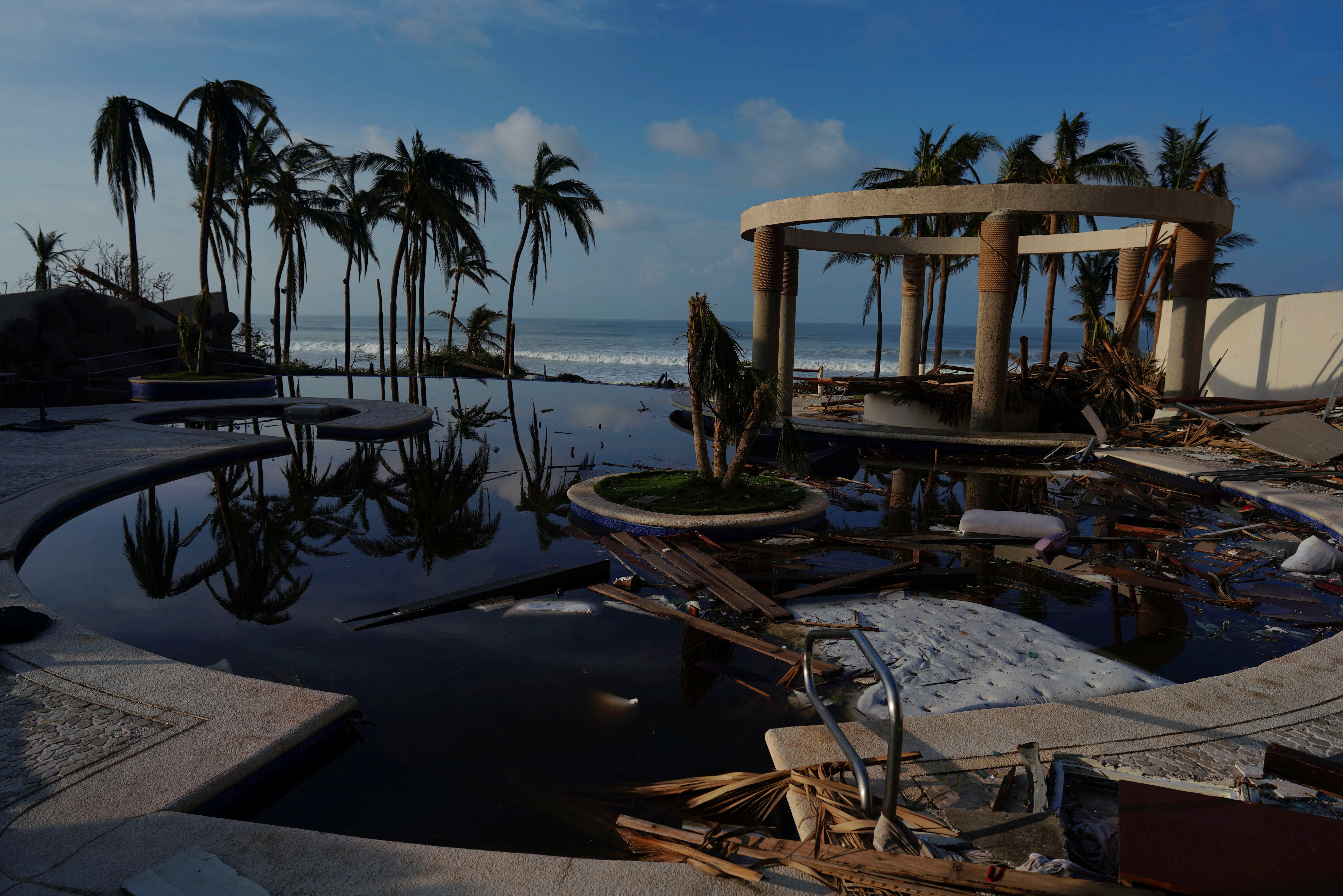 A view of the beach seen from inside a damaged hote