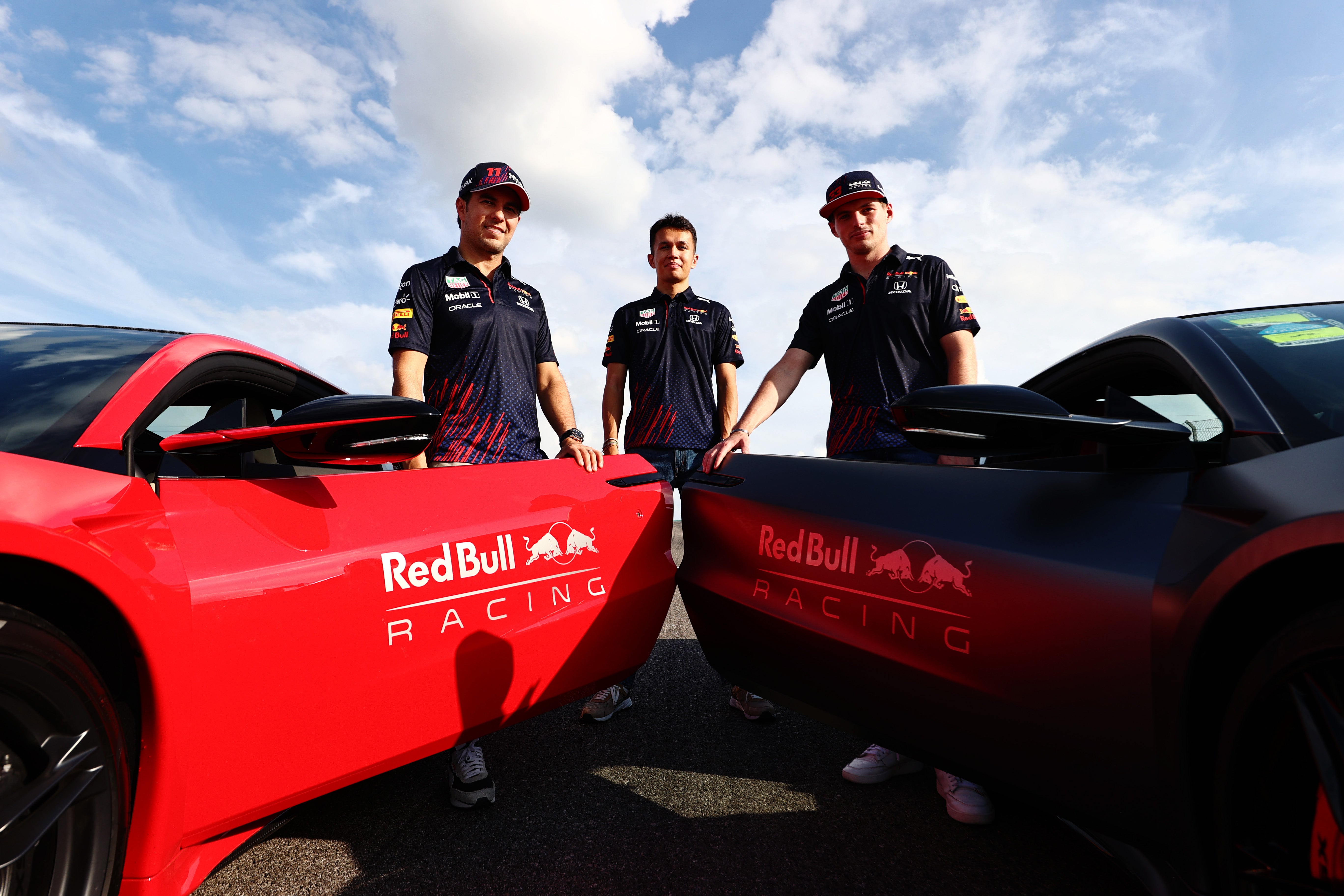 Alex Albon, centre, lost his seat to Perez for the 2021 season but now the Mexican’s future is hanging in the balance