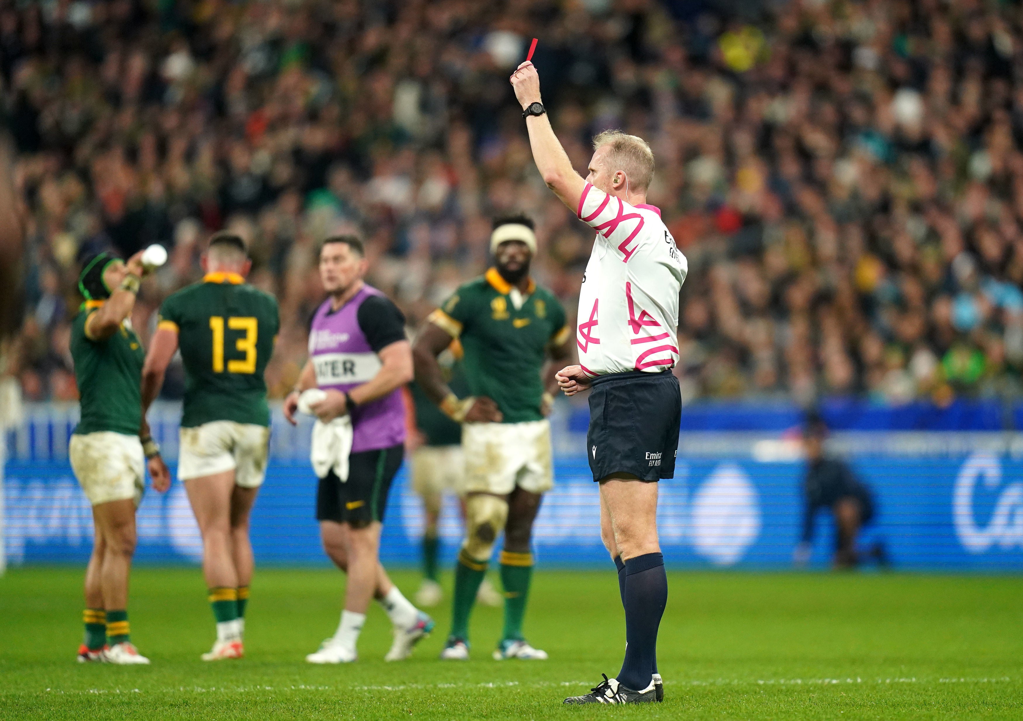 Referee Wayne Barnes shows a red card to New Zealand's Sam Cane