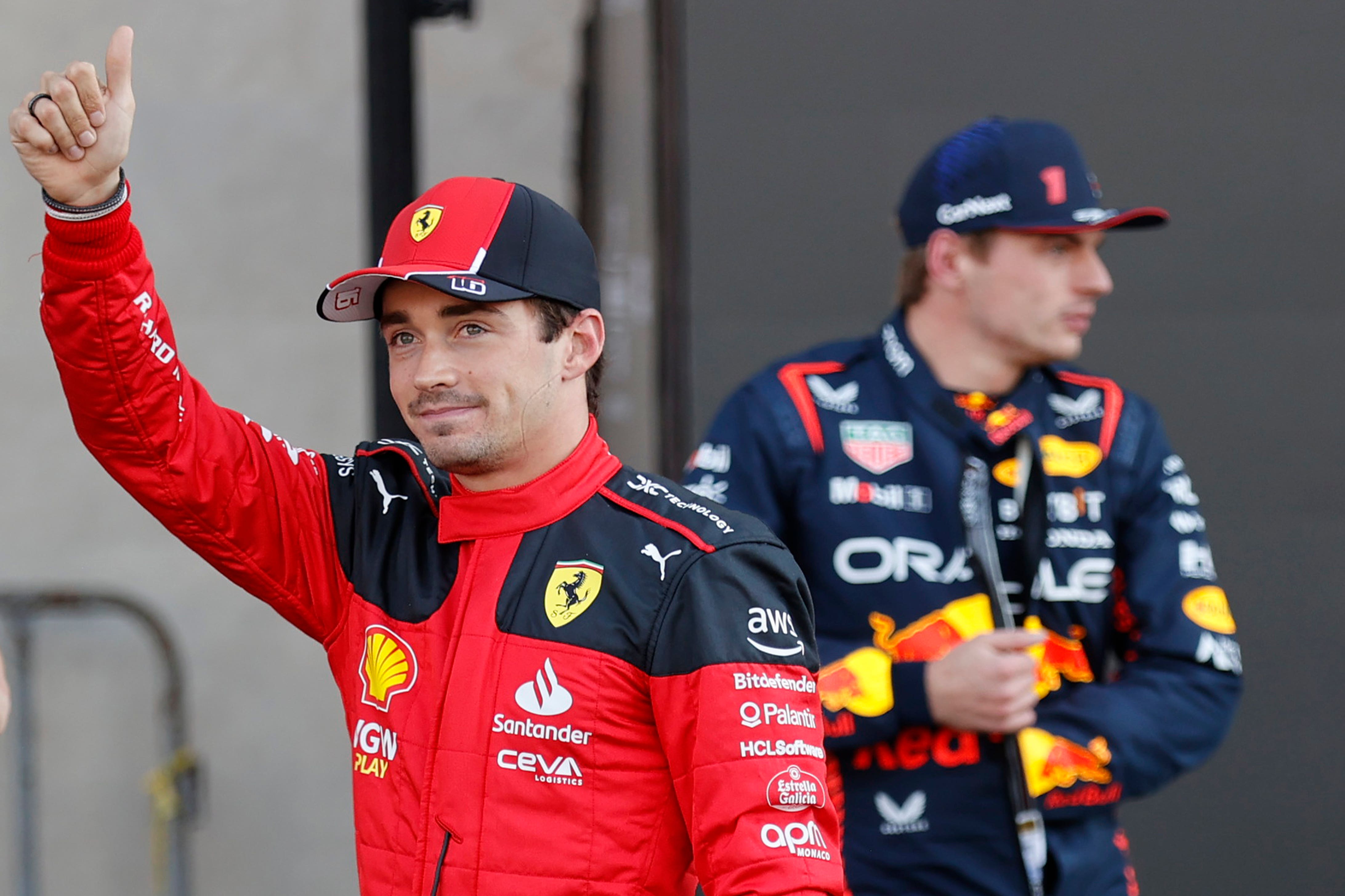 Ferrari driver Charles Leclerc gives a thumbs up as Red Bull driver Max Verstappen of the Netherlands, stands behind him (Andres Staph/Pool photo via AP)