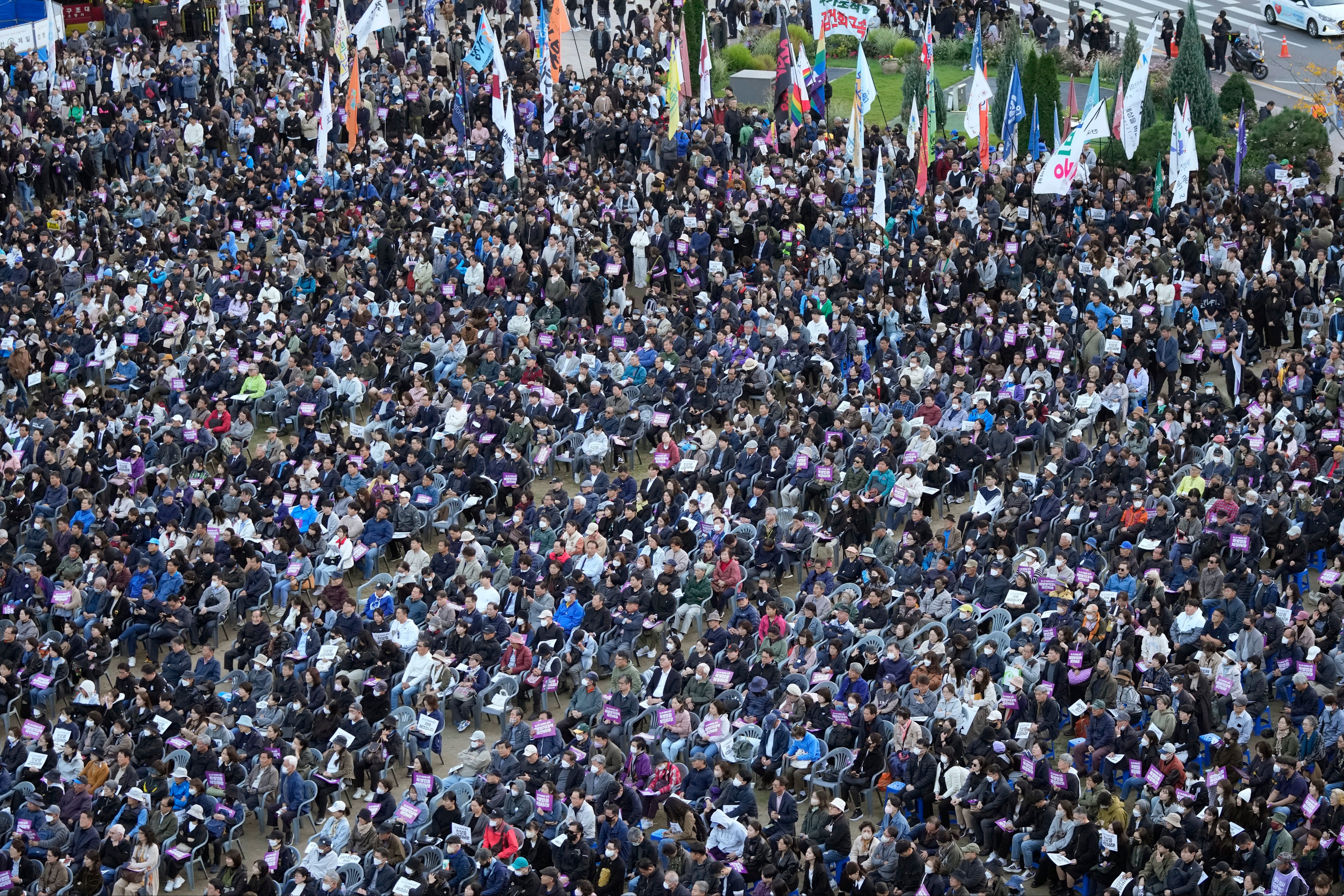 People gather for a rally to mark the first anniversary of the crush that killed more than 150 people