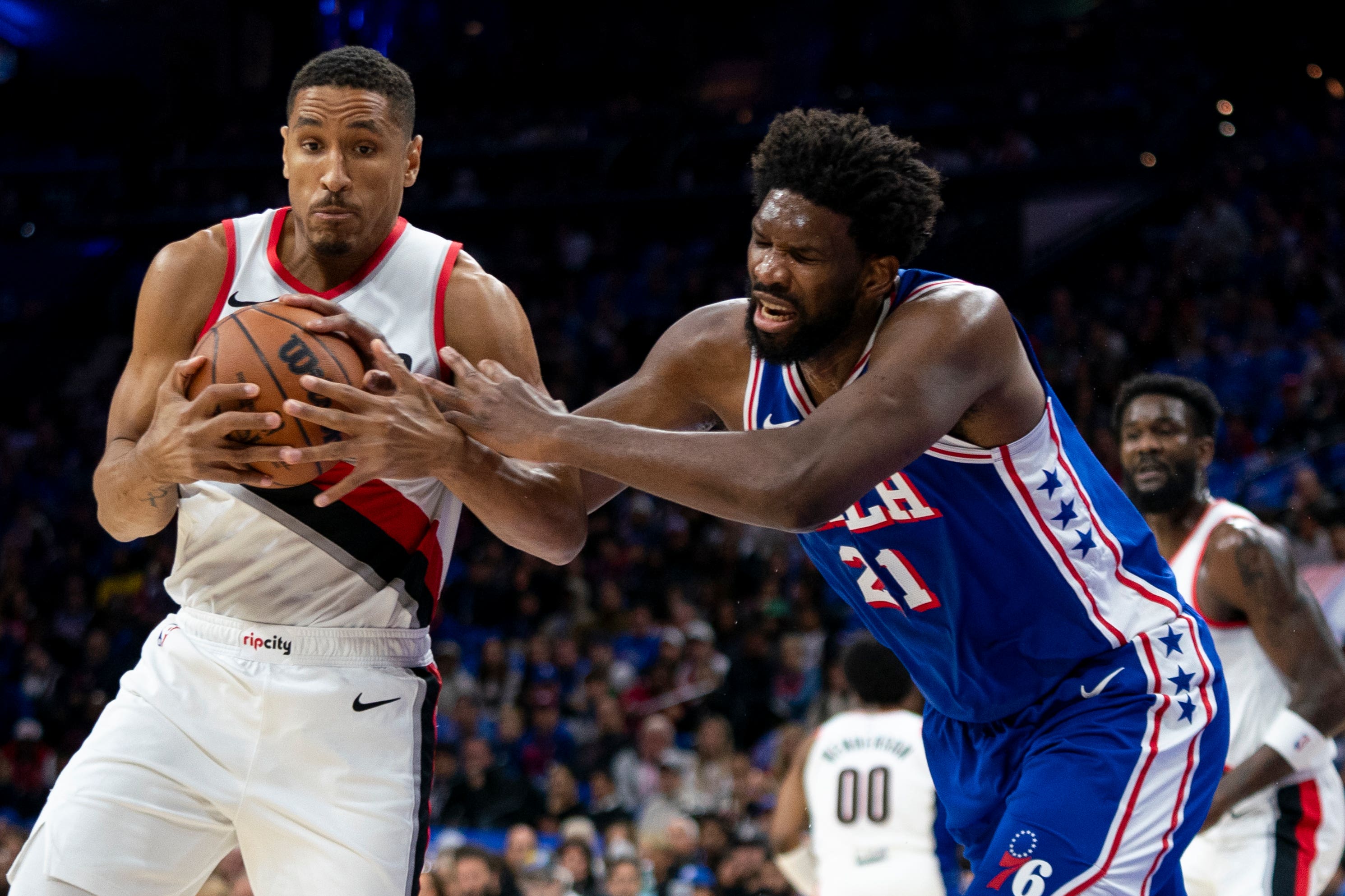 Portland Trail Blazers’ Malcolm Brogdon, left, steals the ball from Philadelphia 76ers’ Joel Embiid, right (Chris Szagola/AP)