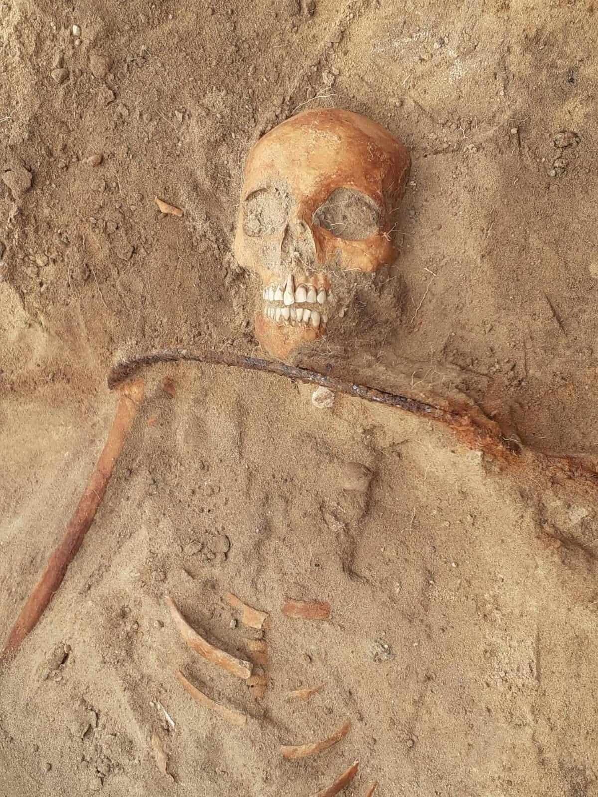 The skeleton of a young woman buried with an iron sickle across her neck as a way of allegedly preventing her from rising from the dead, is seen in Pien, Poland