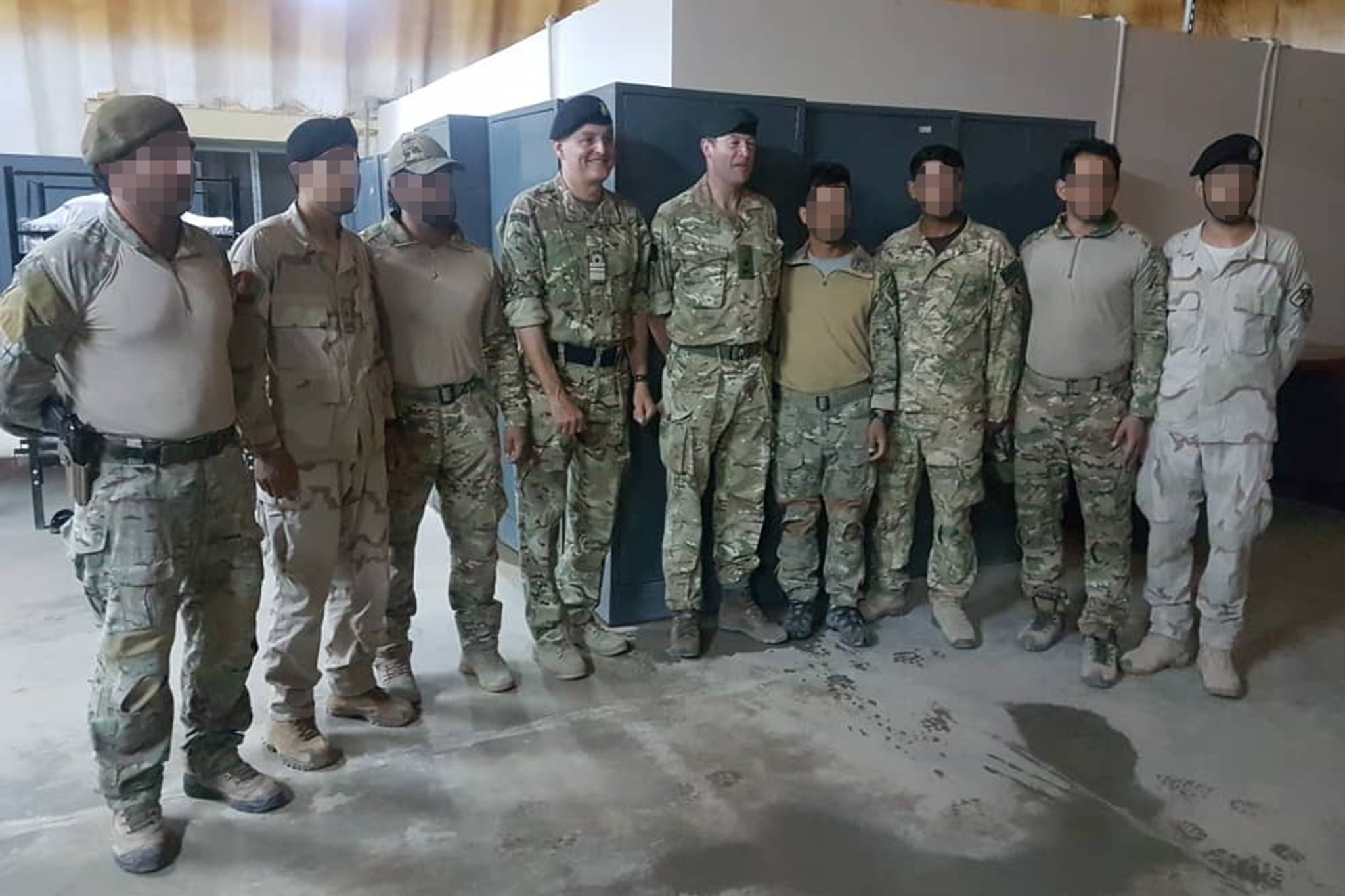 Triples members stand next to Vice Admiral Tim Frazer, then chief of joint operations (centre left), and General Patrick Sanders, now chief of the general staff (centre right)