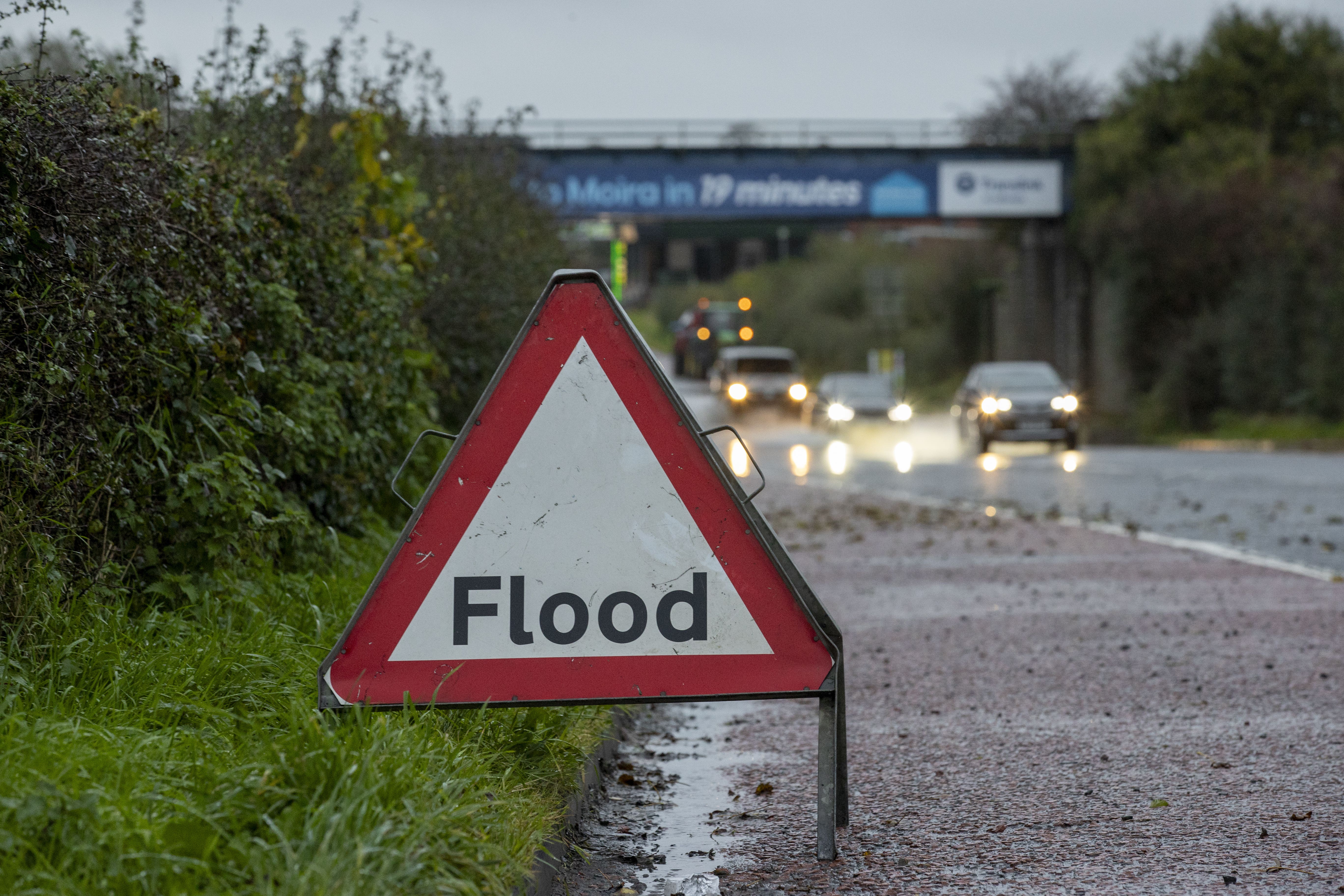 A road sign advising drivers of flooding on the A26 outside Moira in Northern Ireland (Liam McBurney/PA)