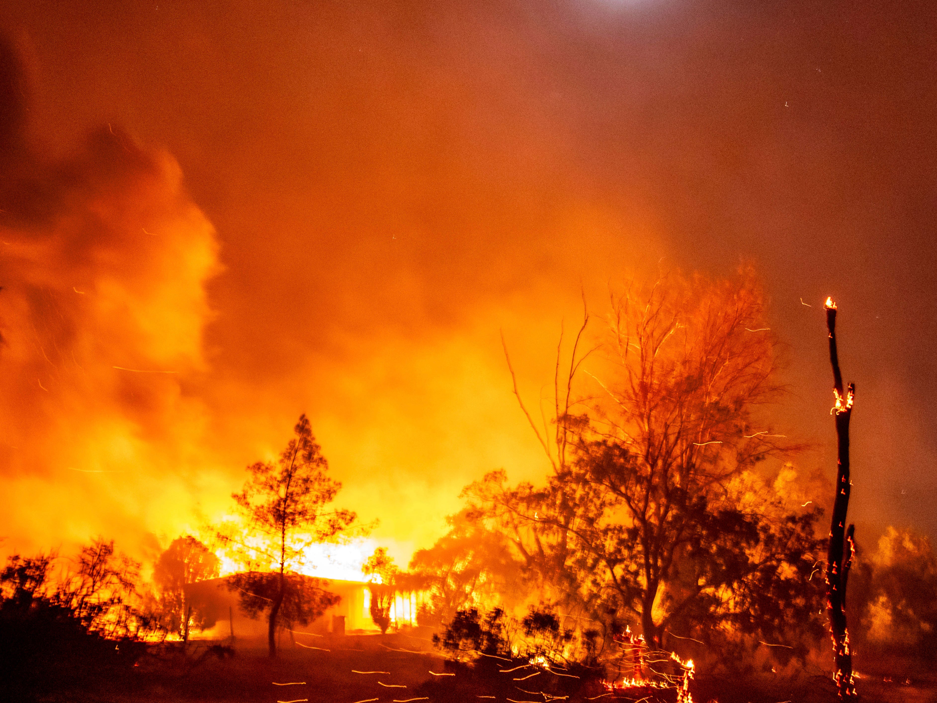 A structure is engulfed in flames as the Highland Fire burns in Aguanga, California on Monday, October 30, 2023