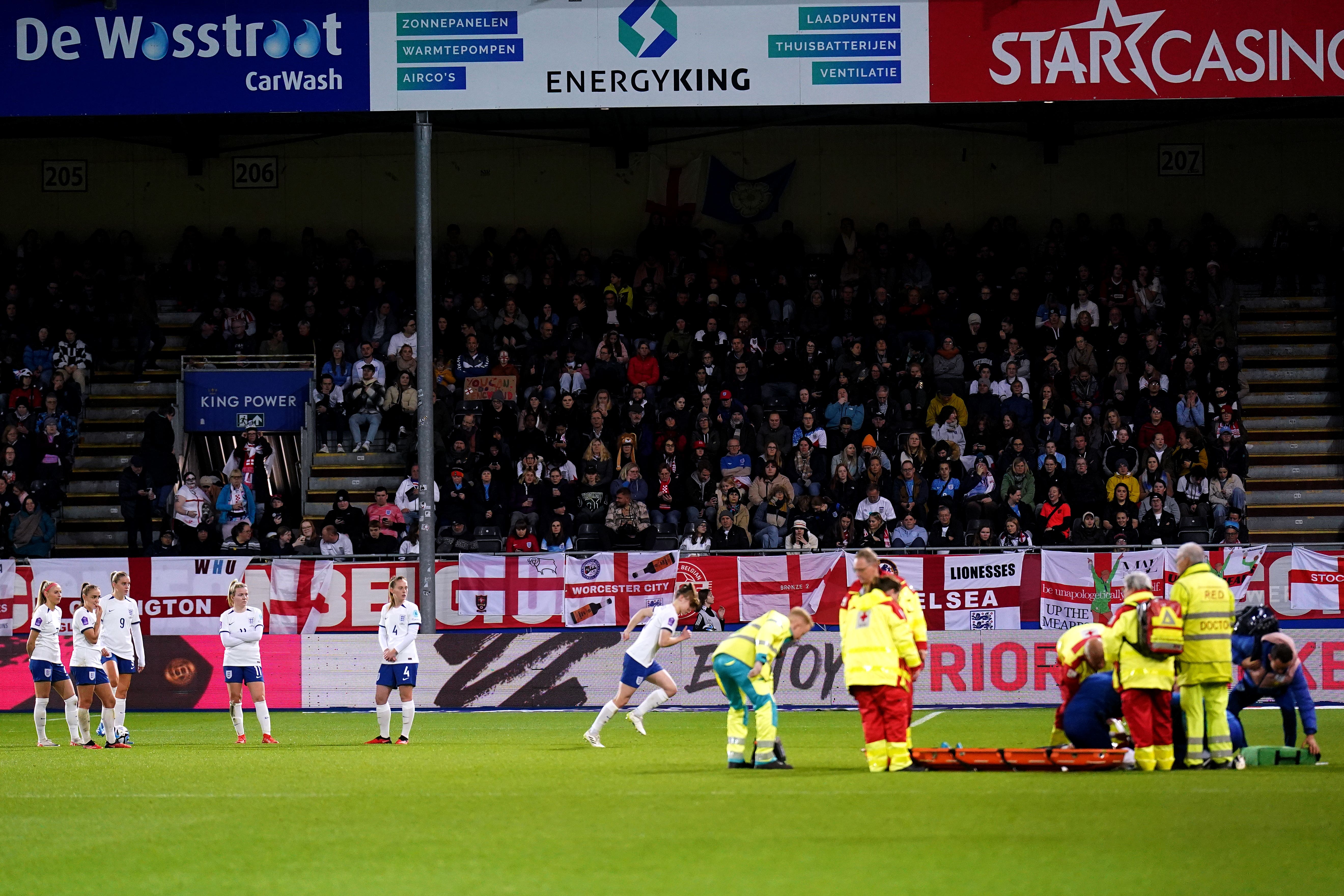 England players look on as Alex Greenwood receives medical attention on the field (Rene Nijhuis/PA)