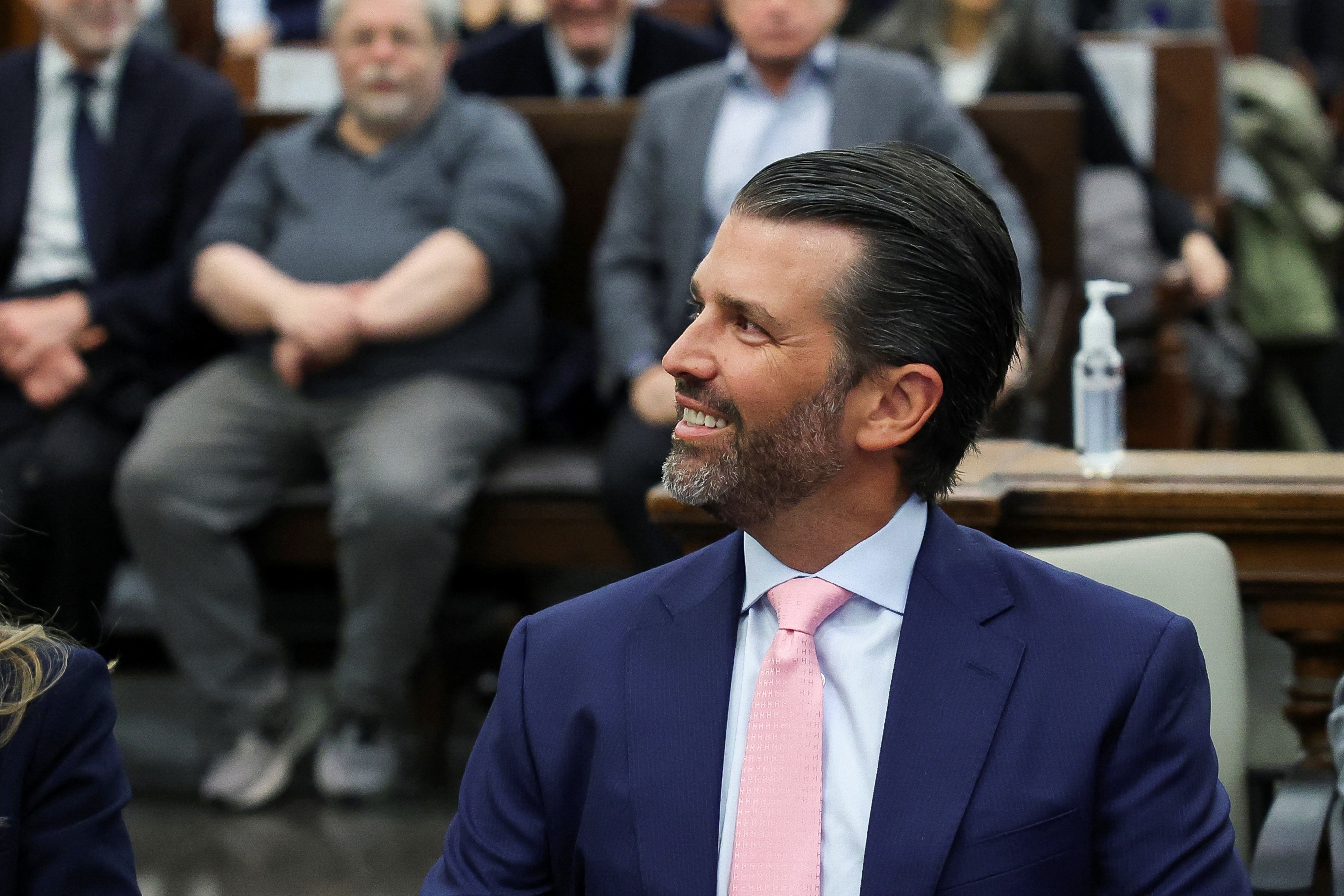 Donald Trump Jr sits with attorneys for the Trump family and its chief associates before he walks to the witness stand in New York Supreme Court on 1 November