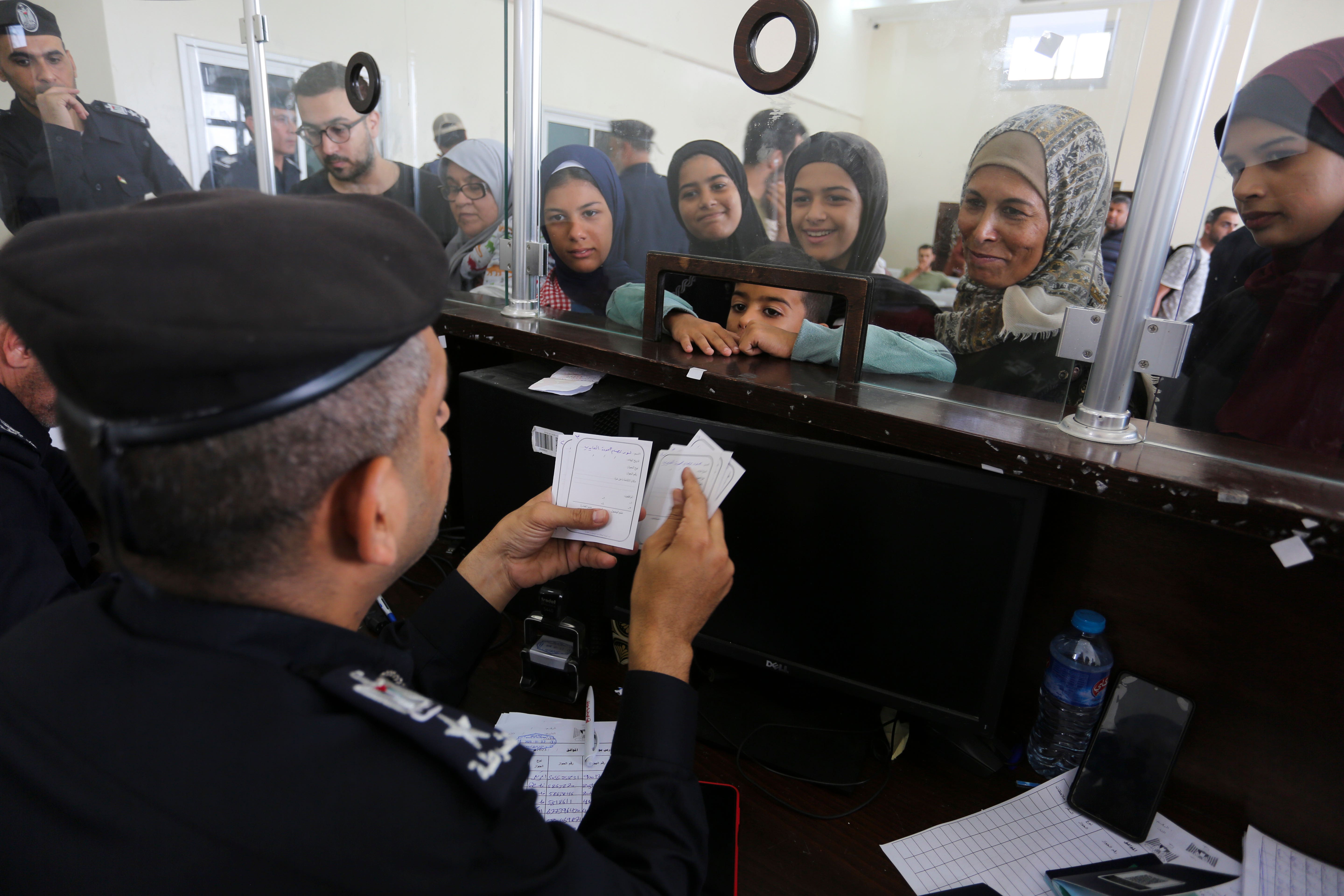 Palestinians with dual nationality register to cross to Egypt from the Gaza Strip