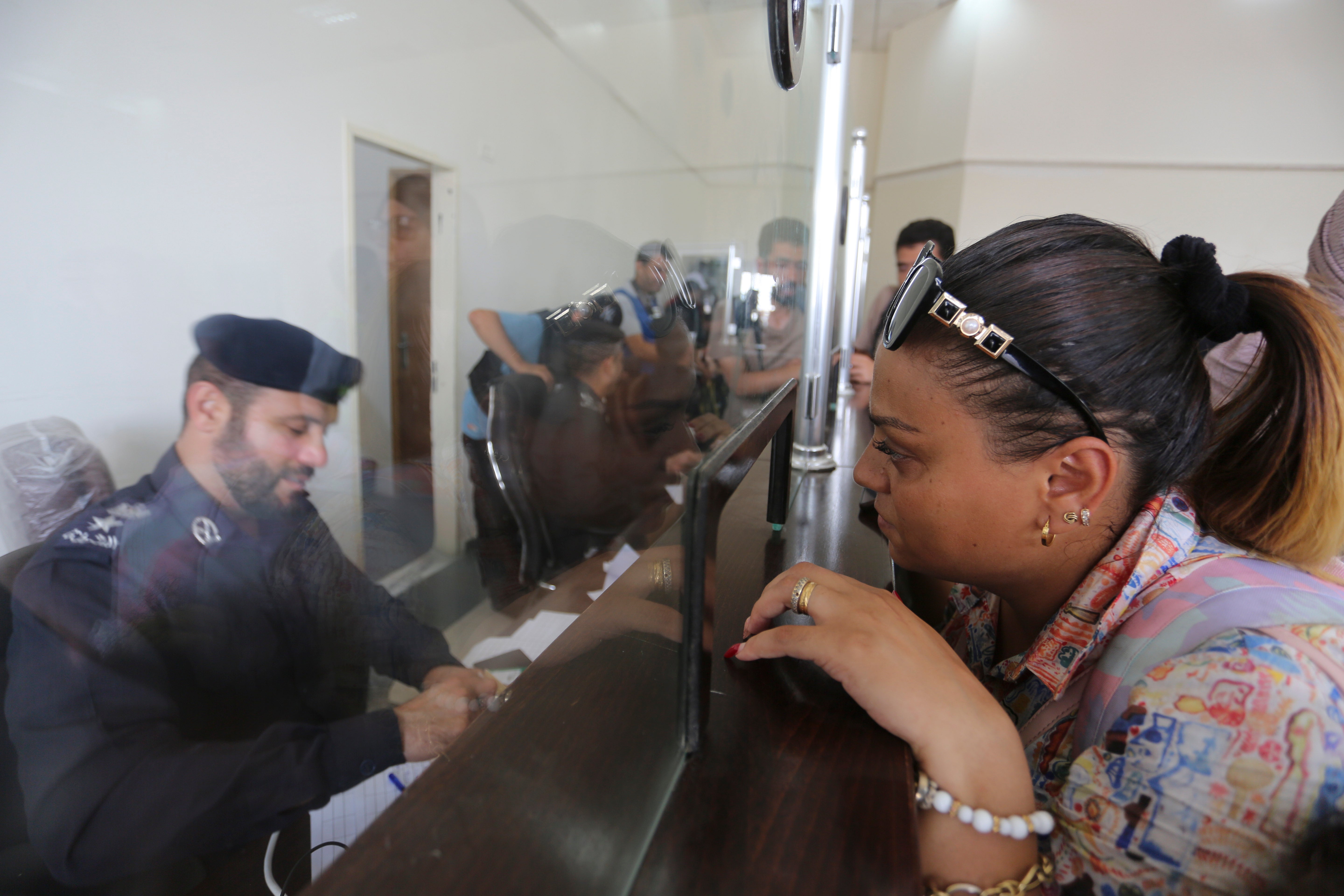 Palestinians with dual nationality register to cross to Egypt on the Gaza Strip side of the border crossing in Rafah on Thursday, Nov. 2, 2023.