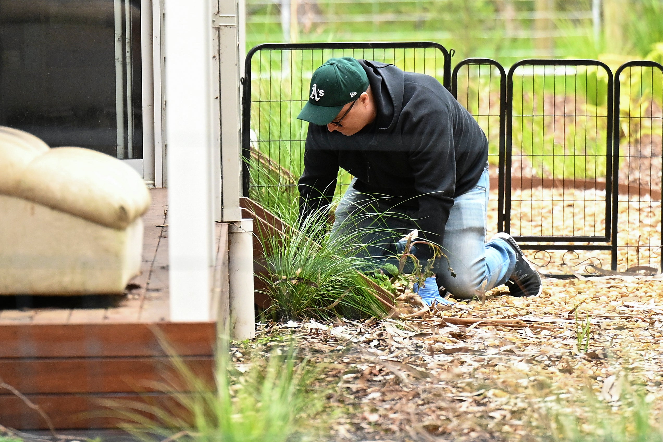 A detective searches the property of Erin Patterson in Leongatha, Australia