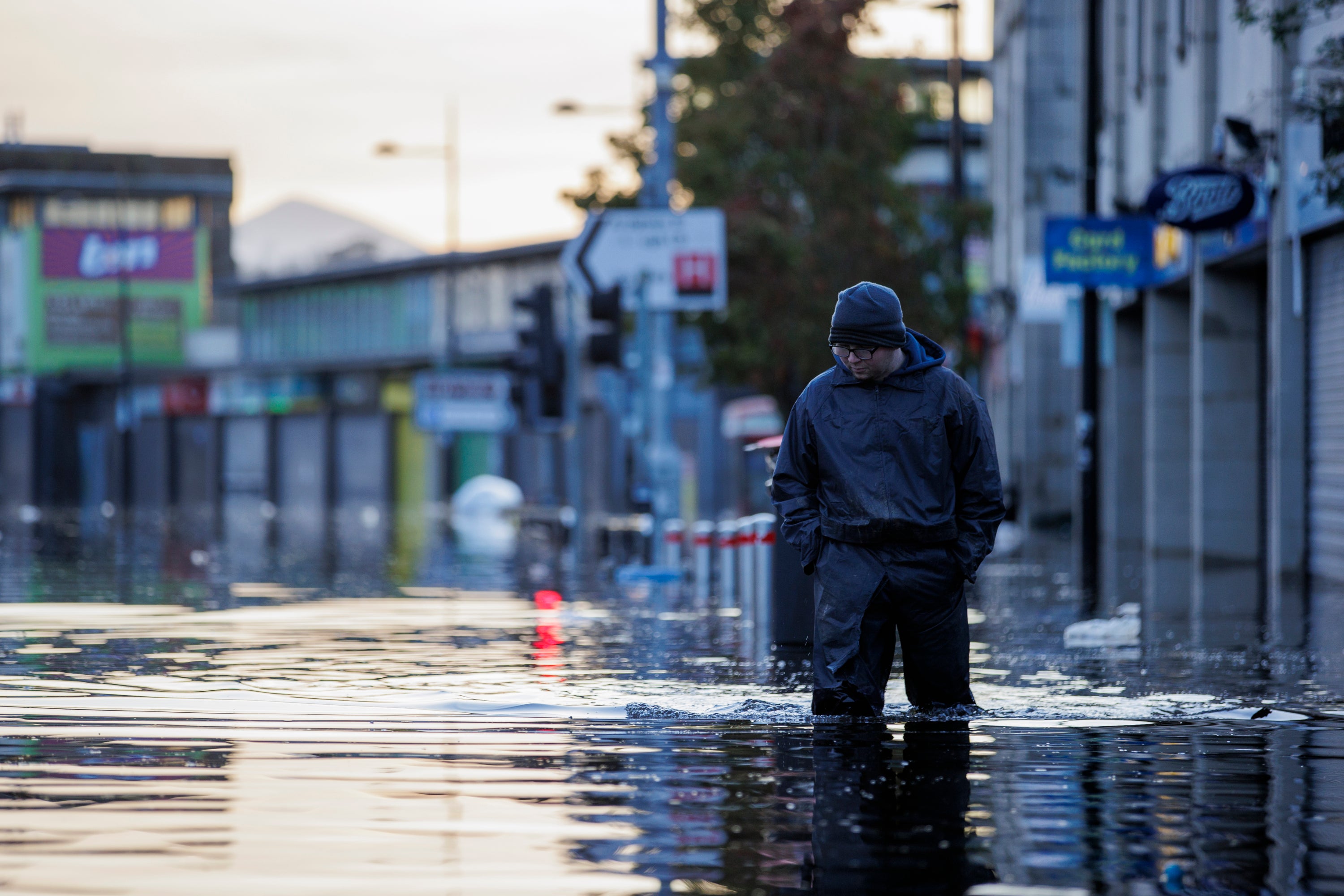 A person walks through flood water on Market Street in Downpatrick