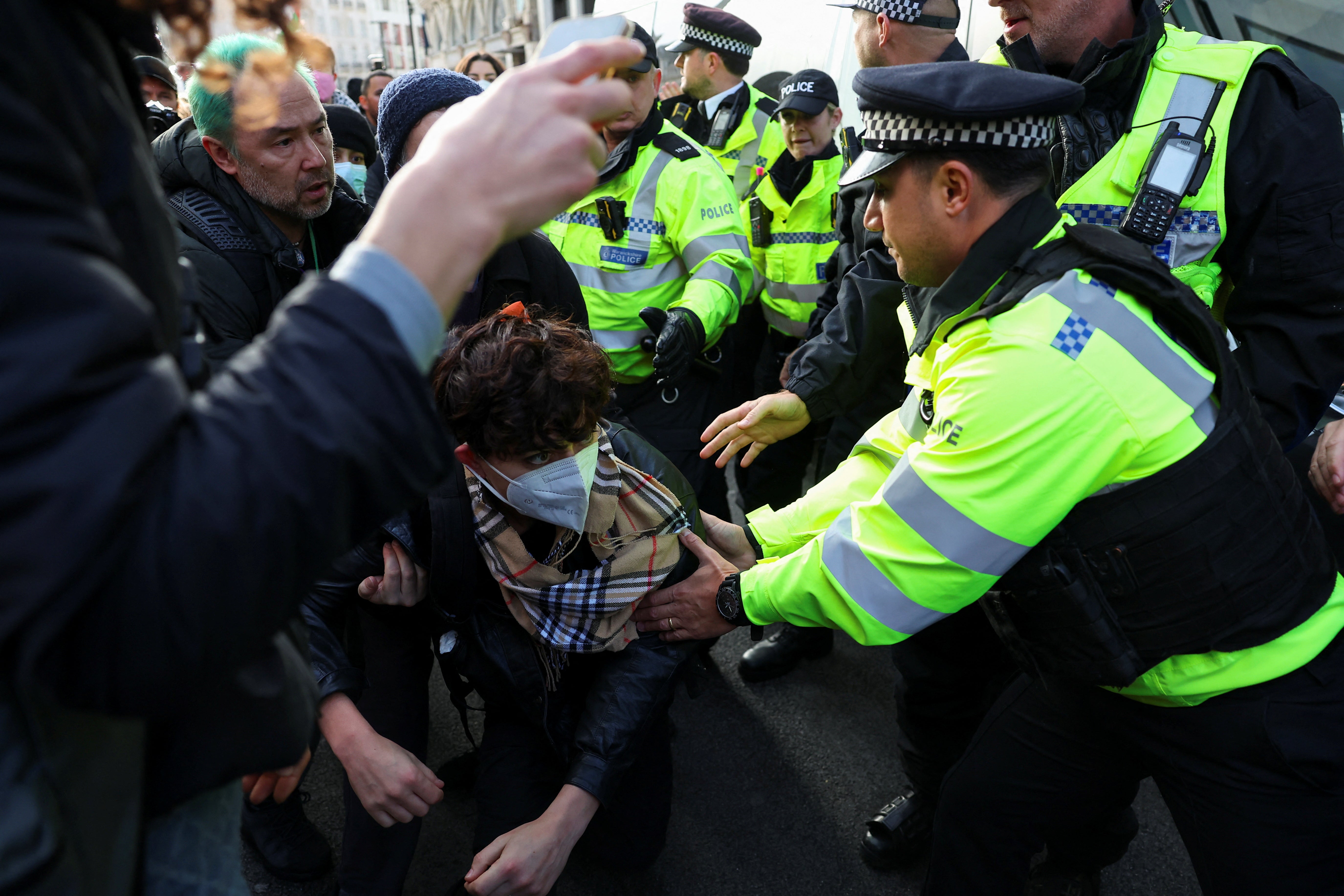 A police officer detains a demonstrator taking part in a protest in solidarity with Palestinians in Gaza in London REUTERS/Toby Melville