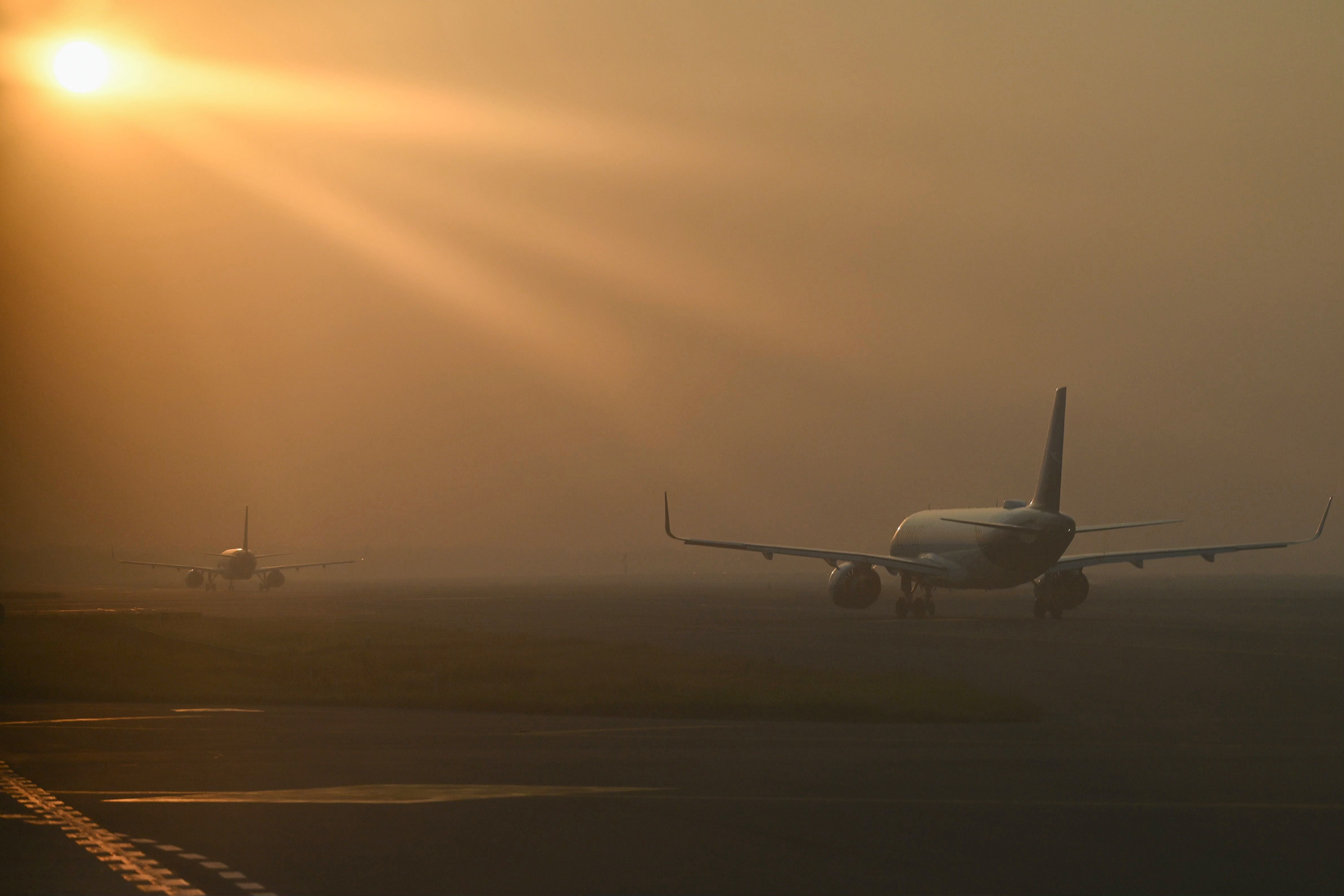 Aircraft line up to take off during heavy air pollution at Indira Gandhi International Airport in New Delhi