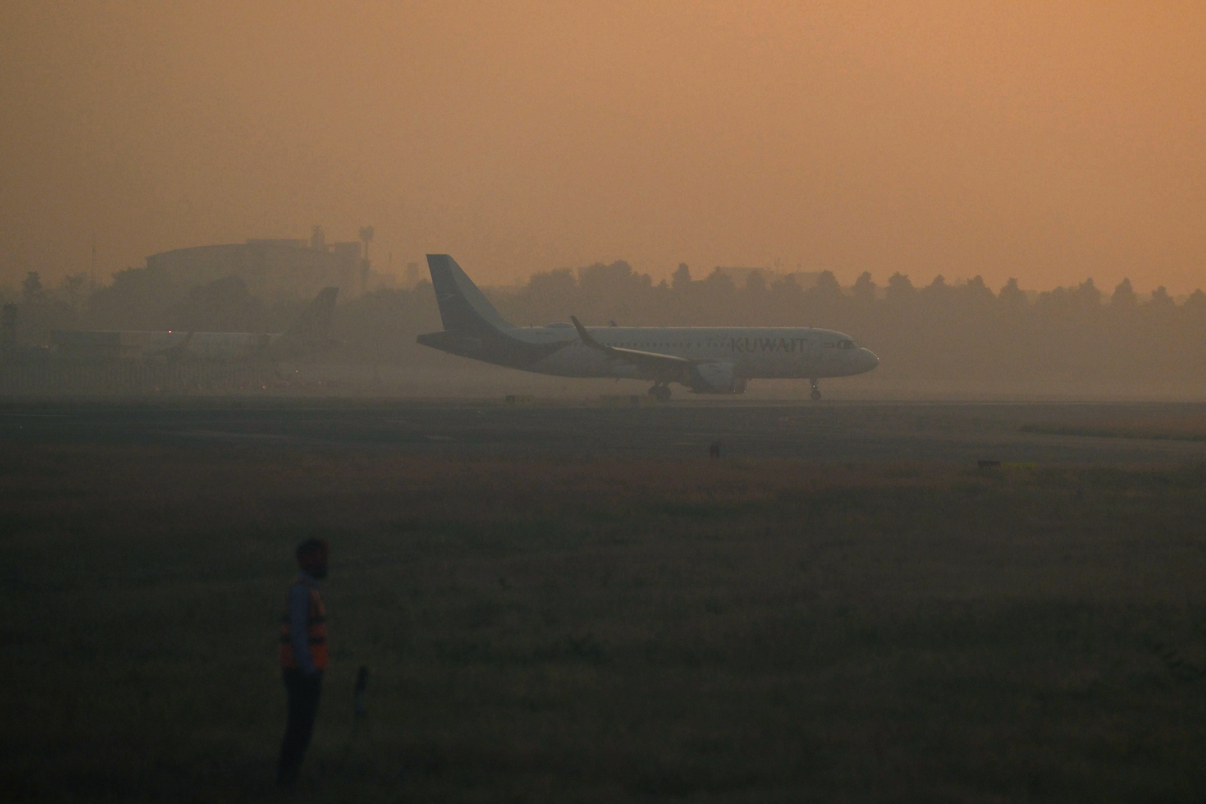 A Kuwait Airways aircraft prepares to take off during heavy air pollution at Indira Gandhi International Airport in New Delhi